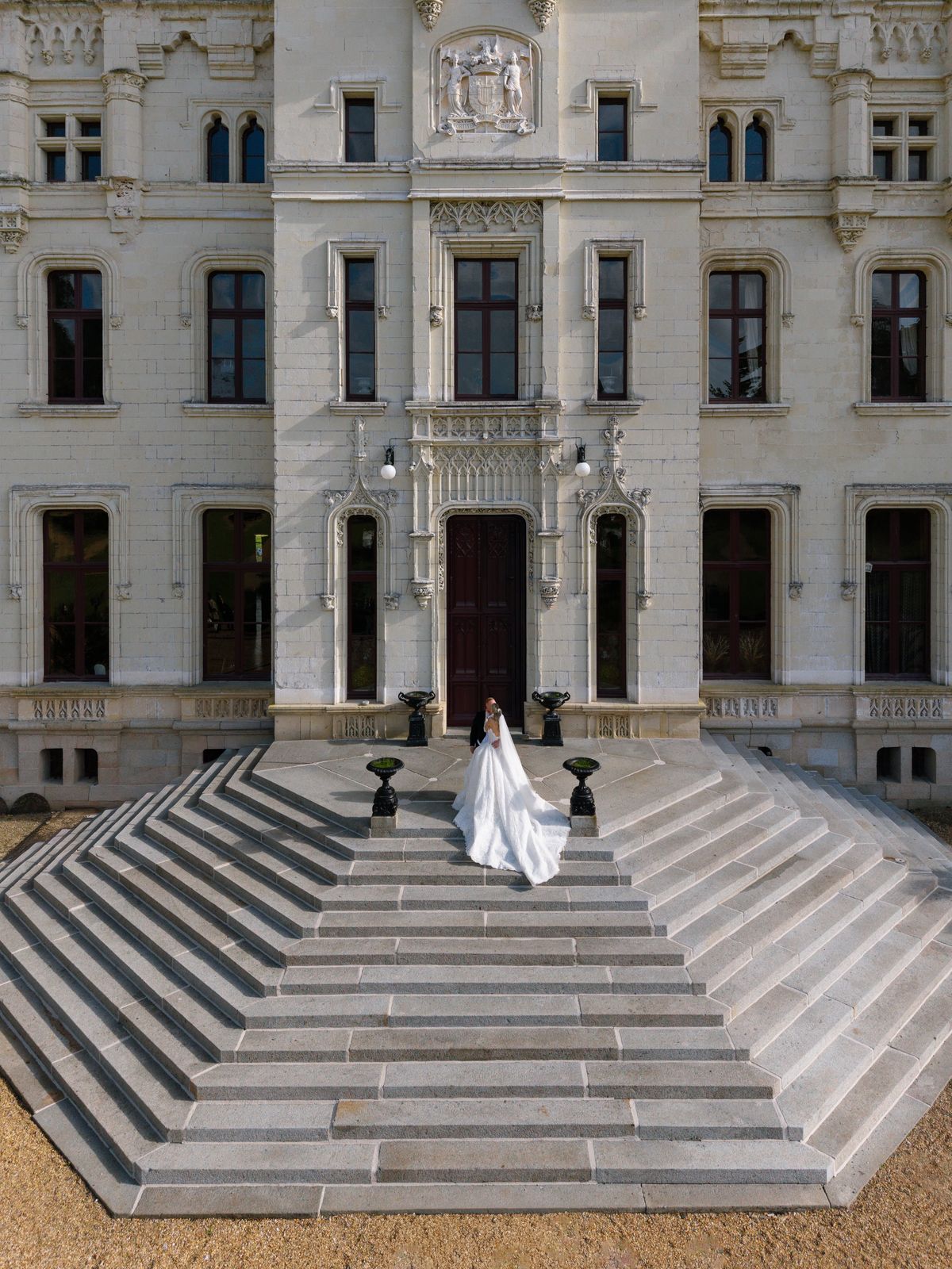Aerial view of Kira on the stone front steps of Chateau Challain