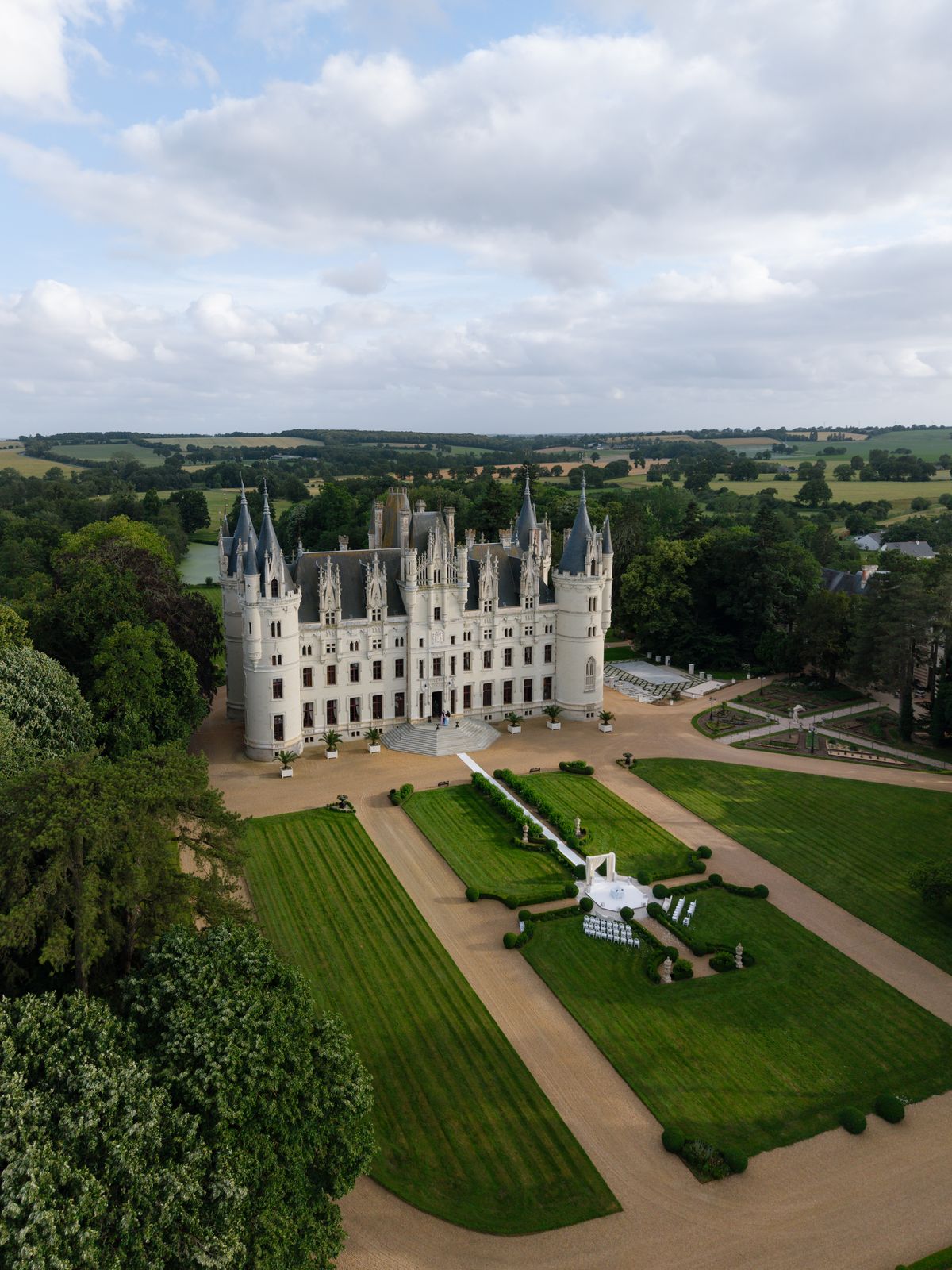 Aerial view of Chateau Challain and its formal gardens with the ceremony set on the lawn