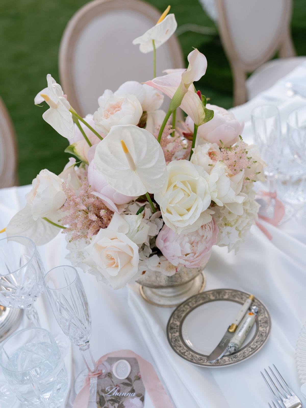 White anthurium, rose and blush peony centrepiece on a dinner table at Chateau Challain