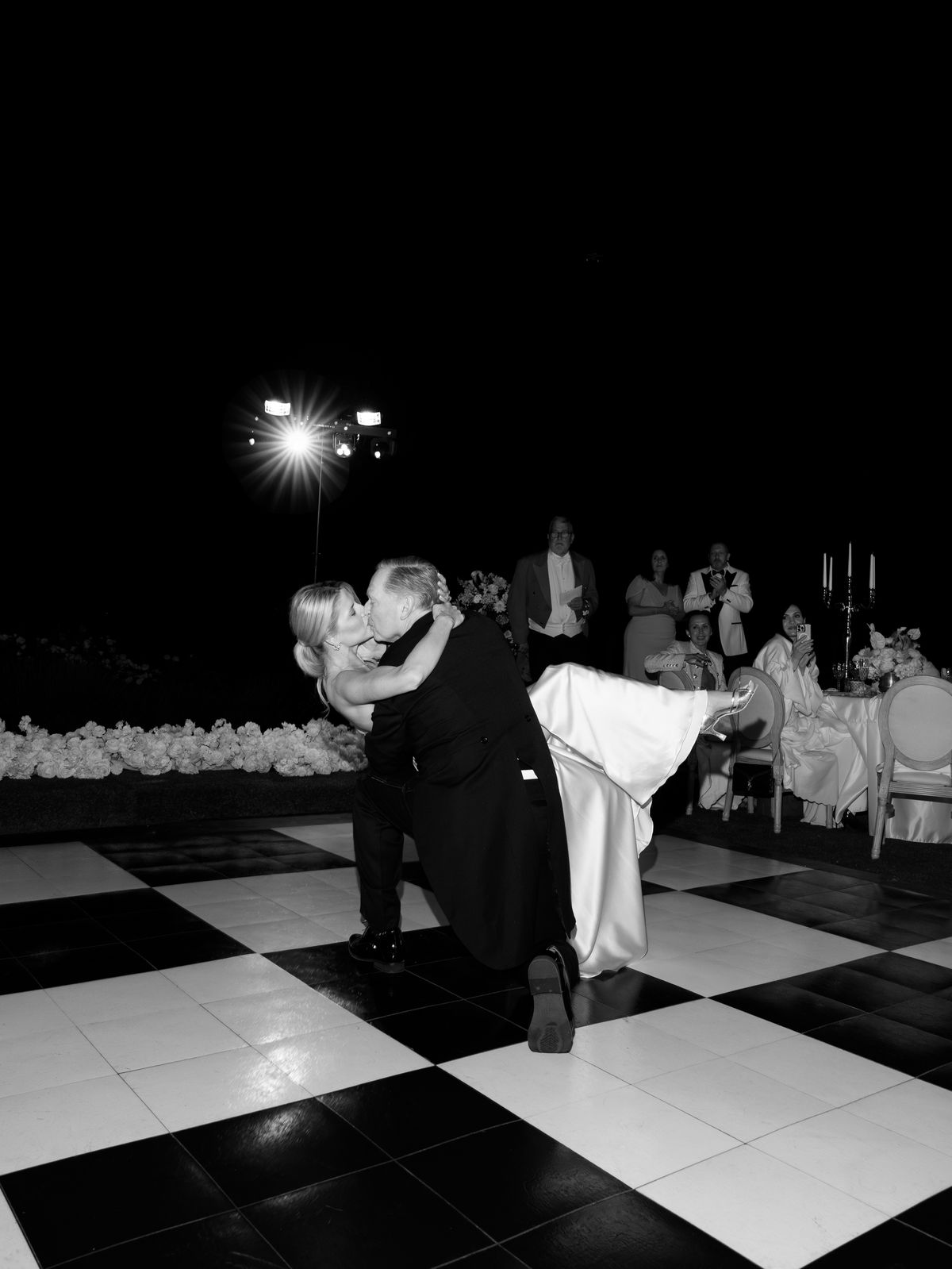 Steve dips Kira on the checkerboard dance floor during their first dance