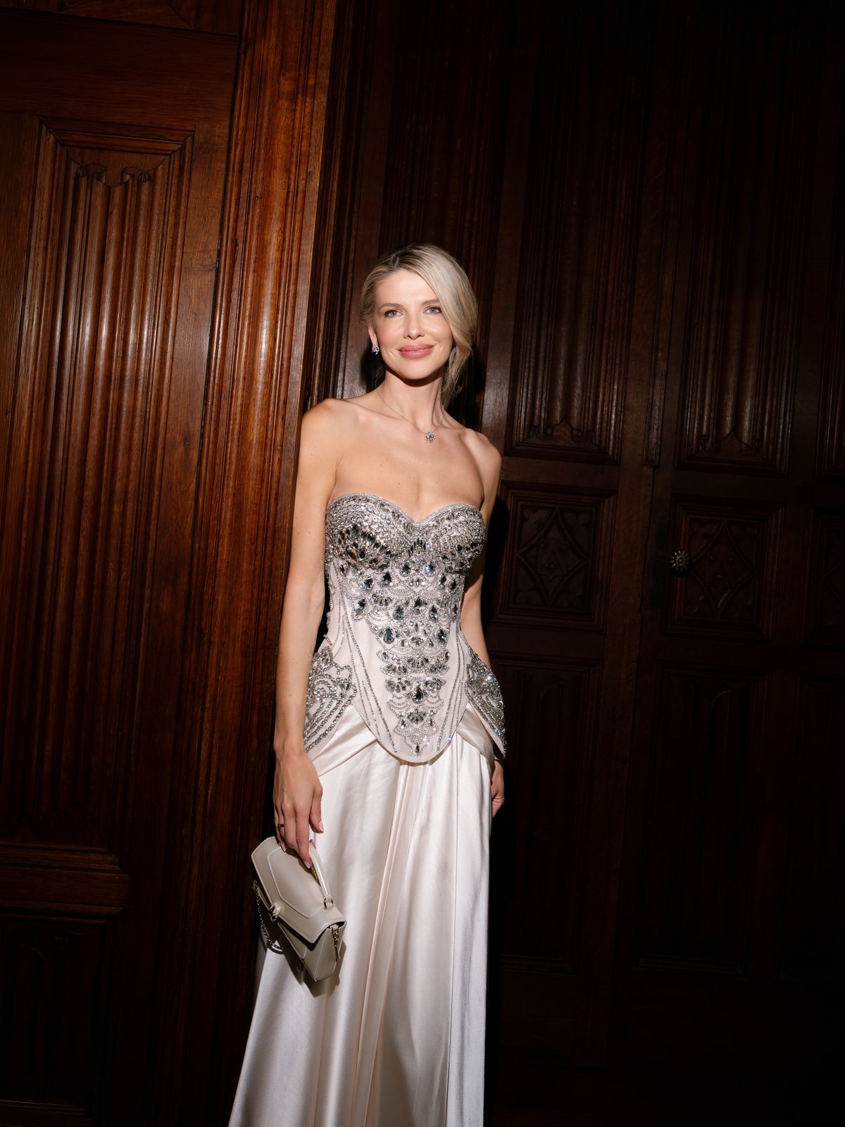 Kira in her crystal corset evening gown against dark wood panelling at Chateau Challain