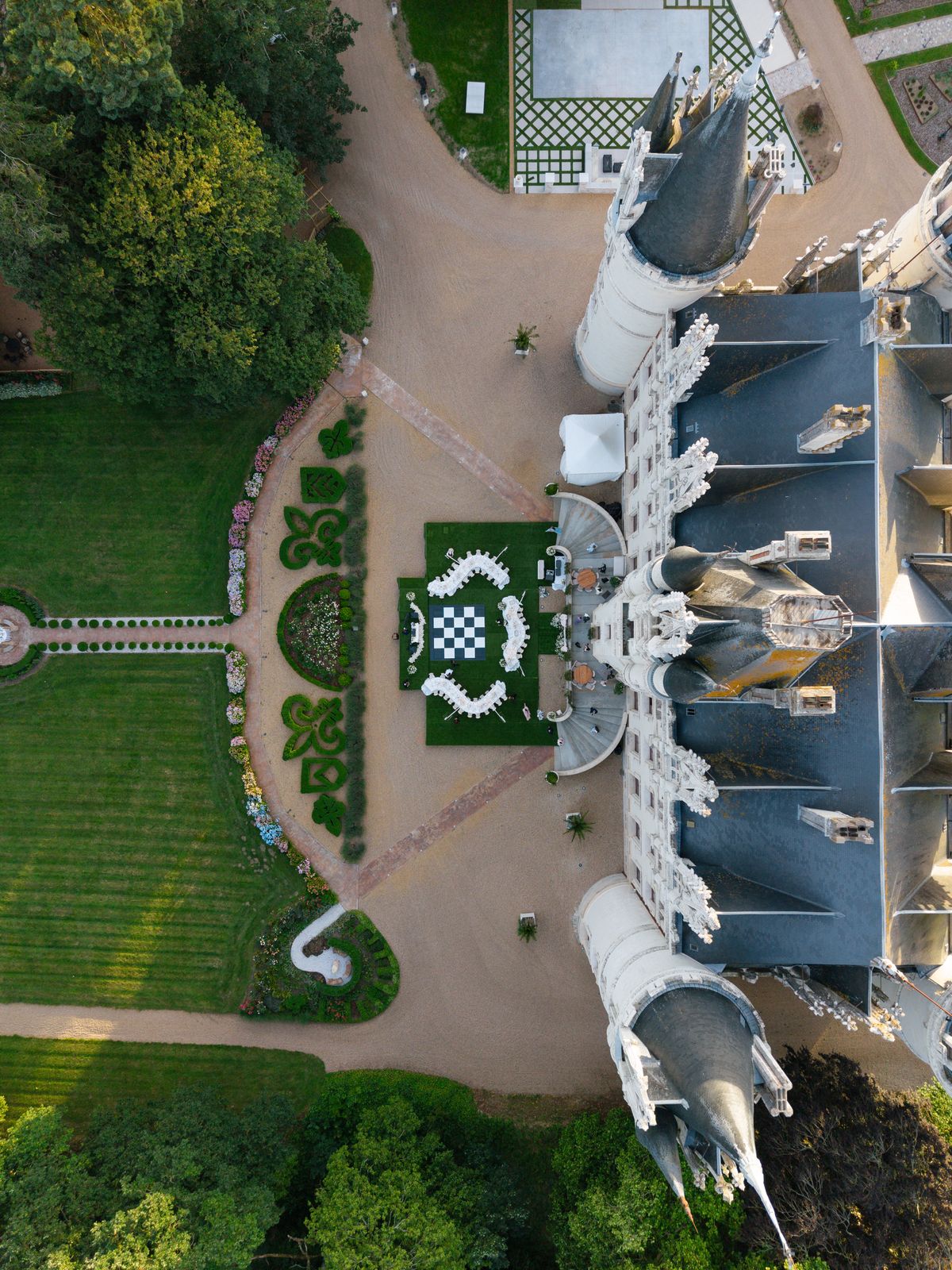 Top-down aerial view of Chateau Challain, its turrets and the reception set in the parterre