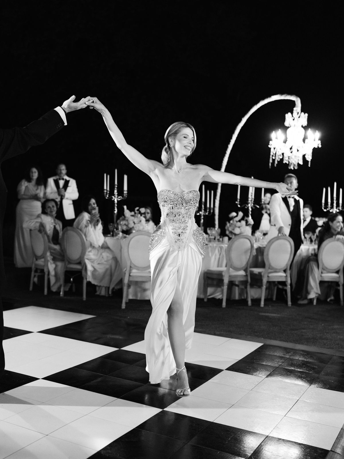 Kira twirls in her crystal corset evening look on the checkerboard dance floor at Chateau Challain