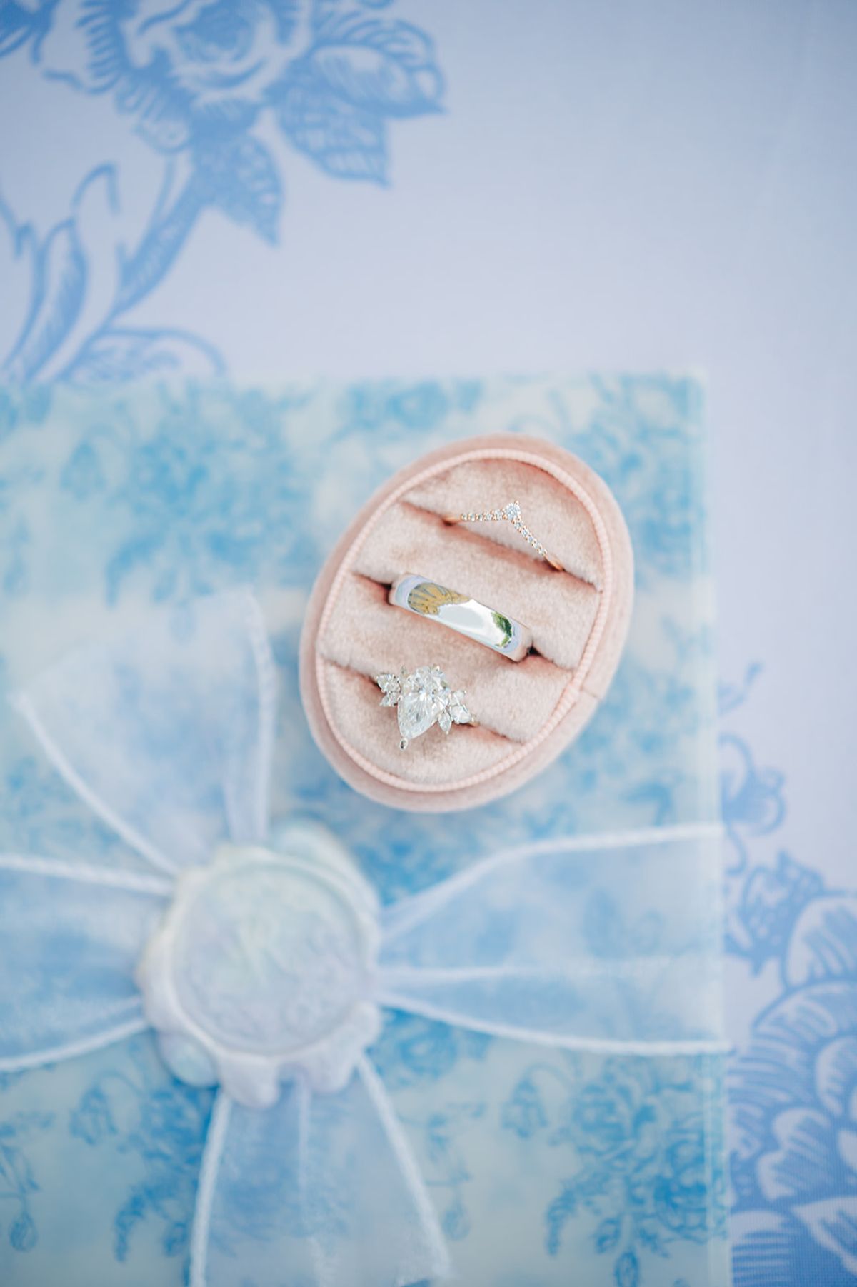 Wedding rings and a wax seal styled together as a detail flat lay