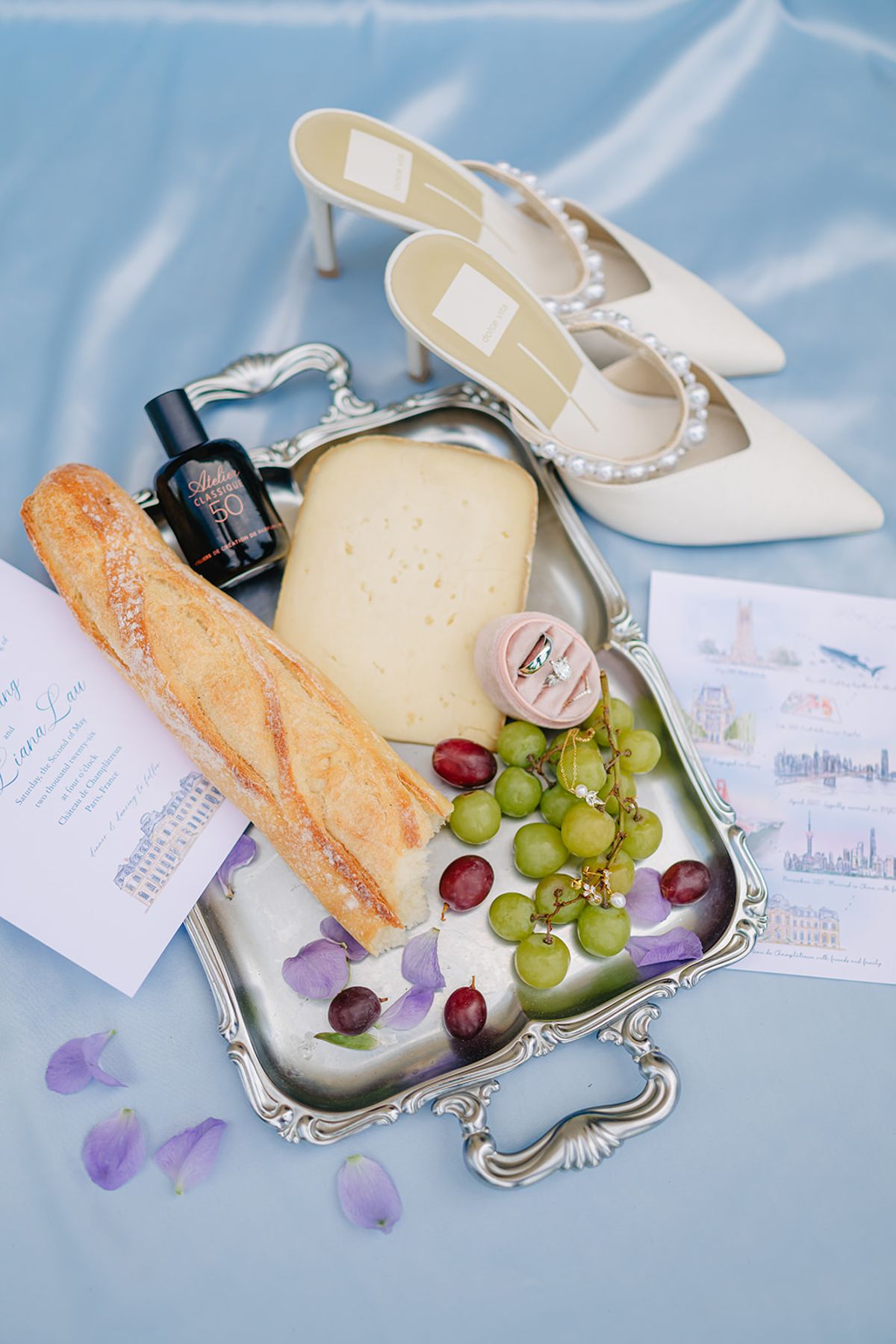 Welcome basket flat lay with bread, cheese, grapes and a hand-illustrated map