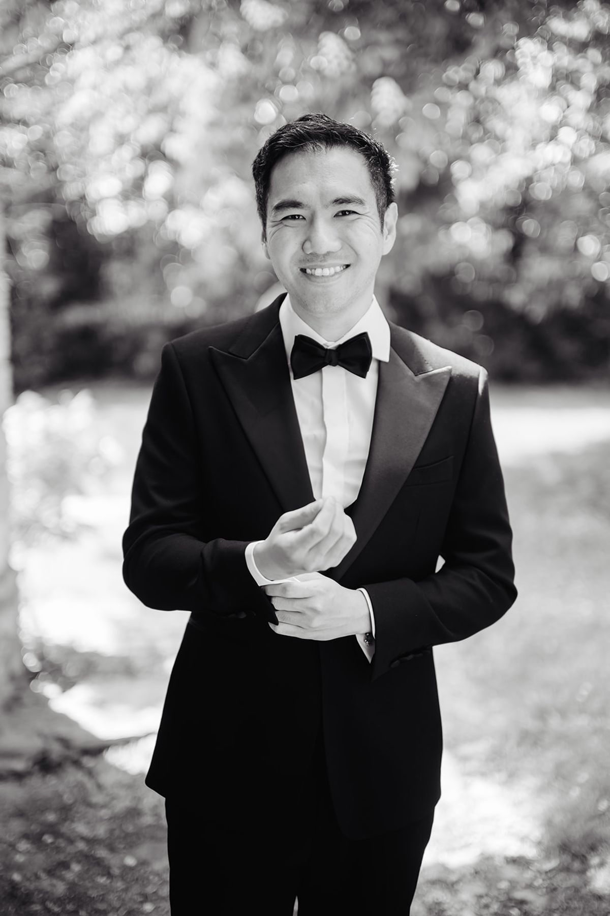 Ruiji fastening his cufflinks, black and white