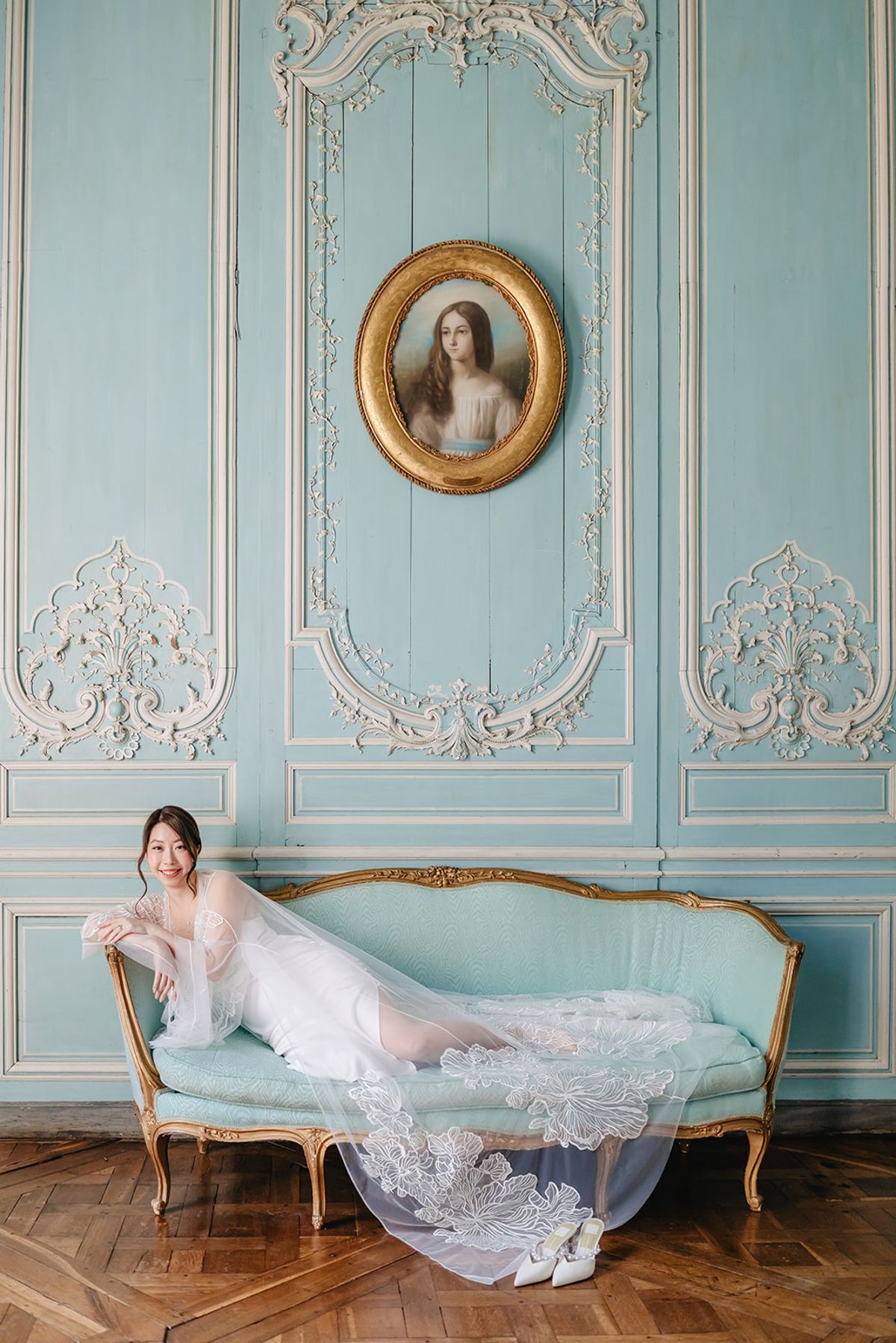 Liana getting ready in a pale blue panelled room at Château de Champlâtreux