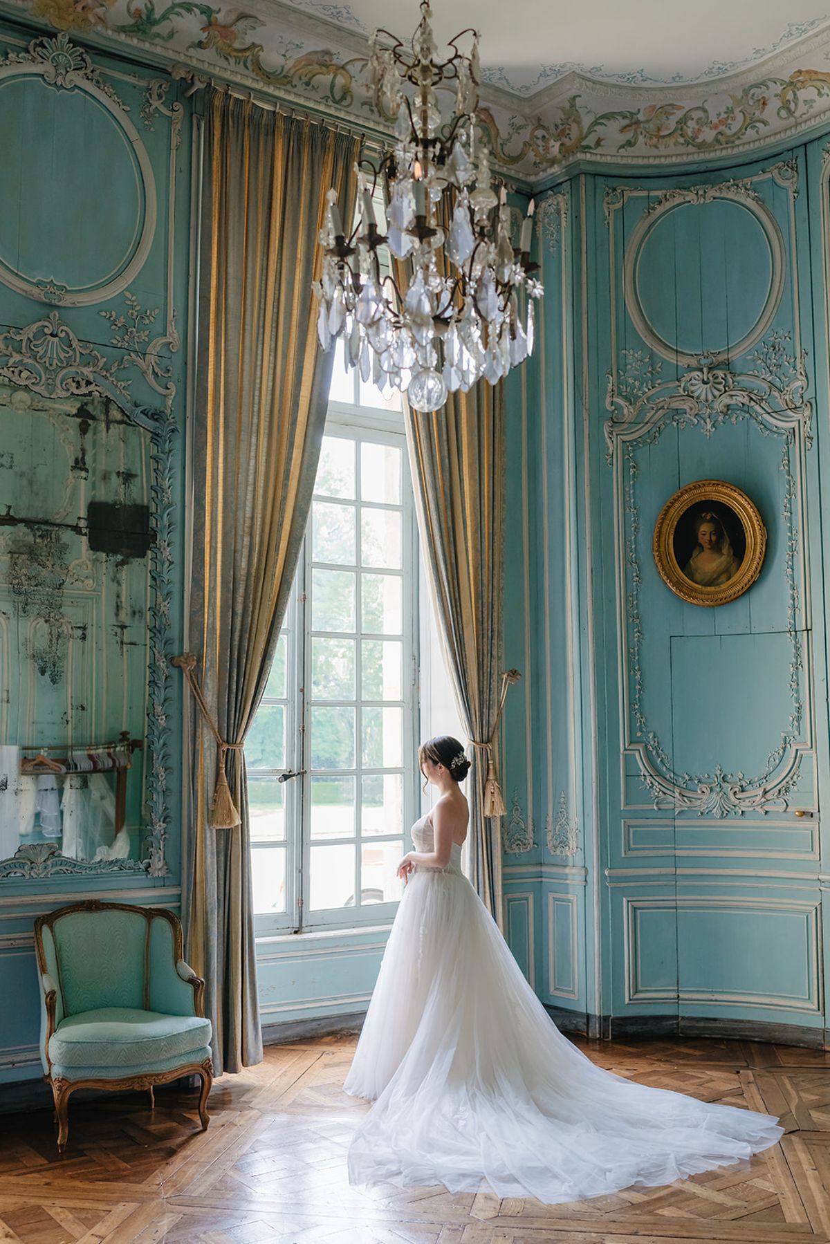 Liana silhouetted by the window in the bridal suite