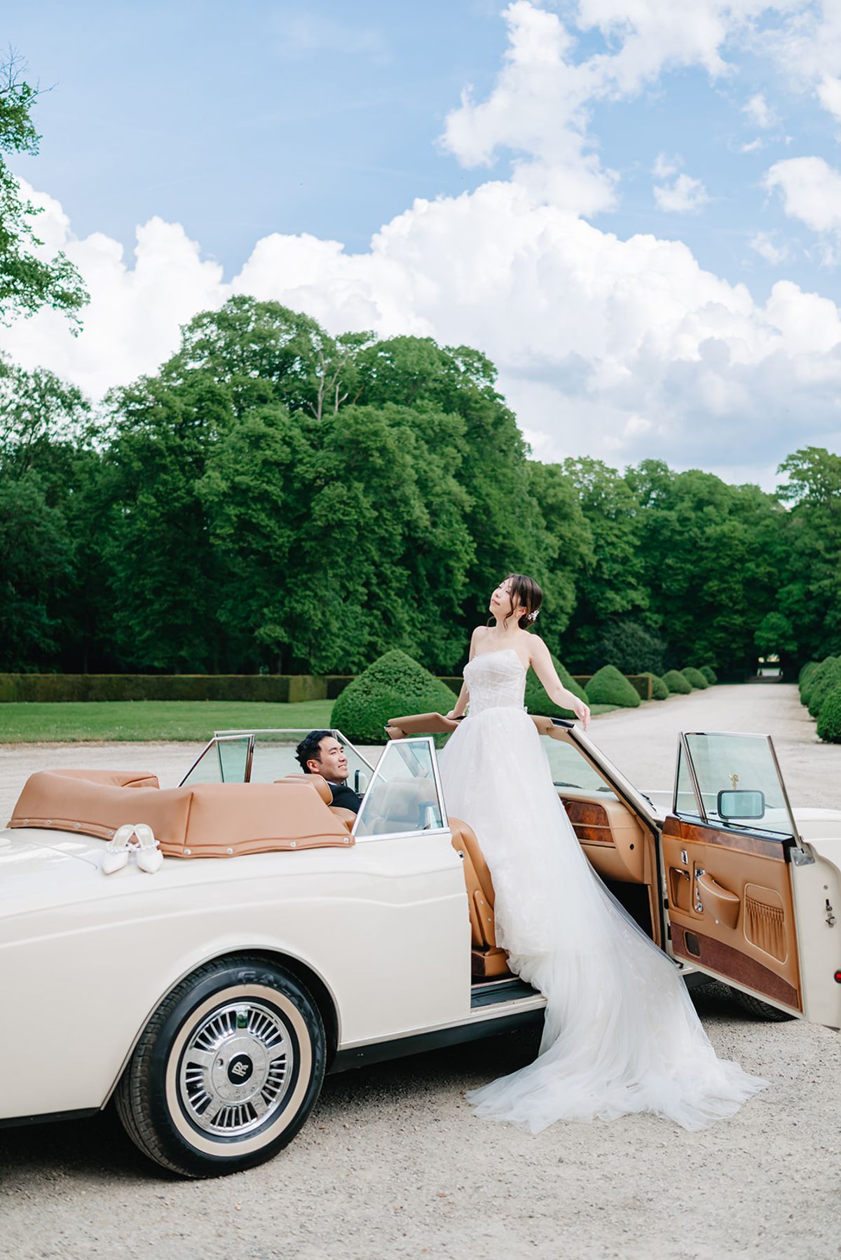 Liana reclining in a vintage convertible, styled solo portrait