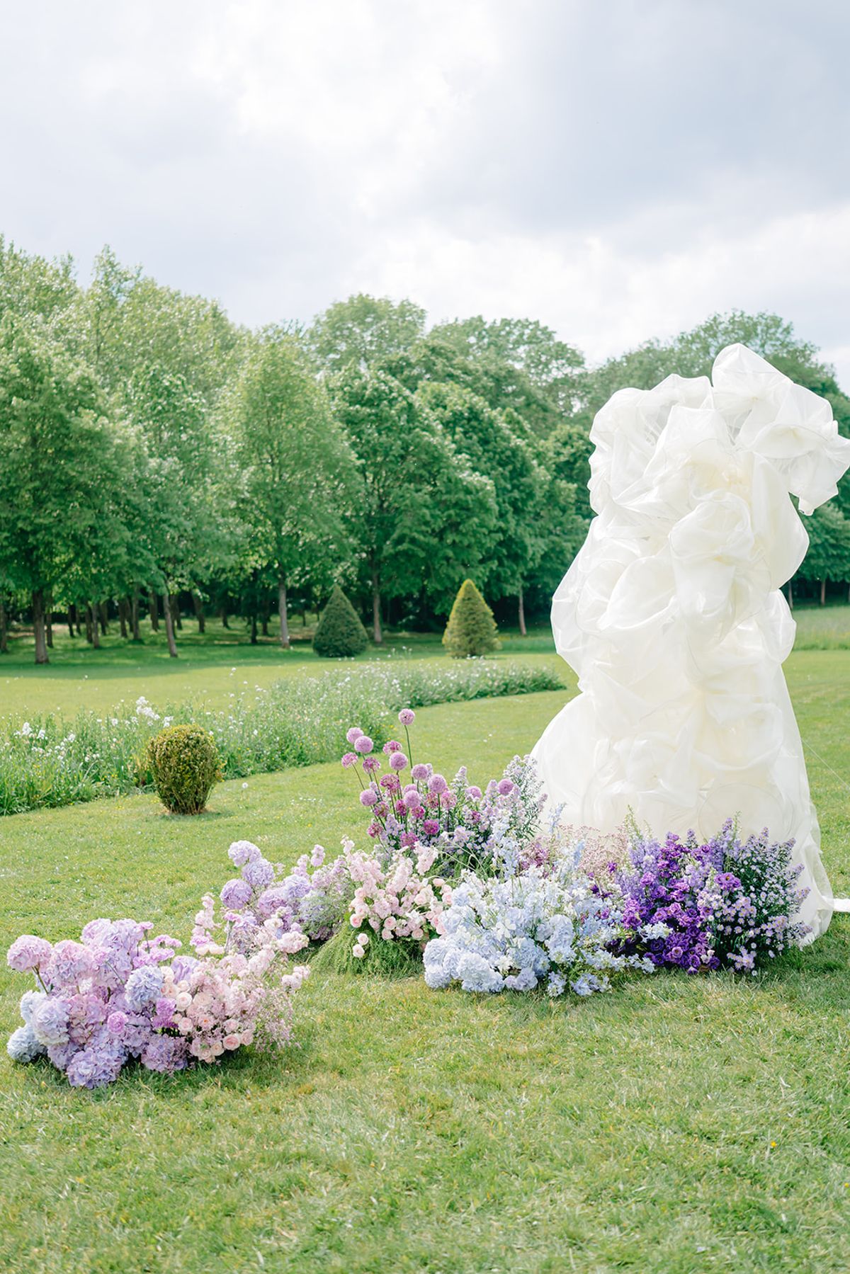 The ceremony's sculptural white floral installation at Château de Champlâtreux, empty of guests