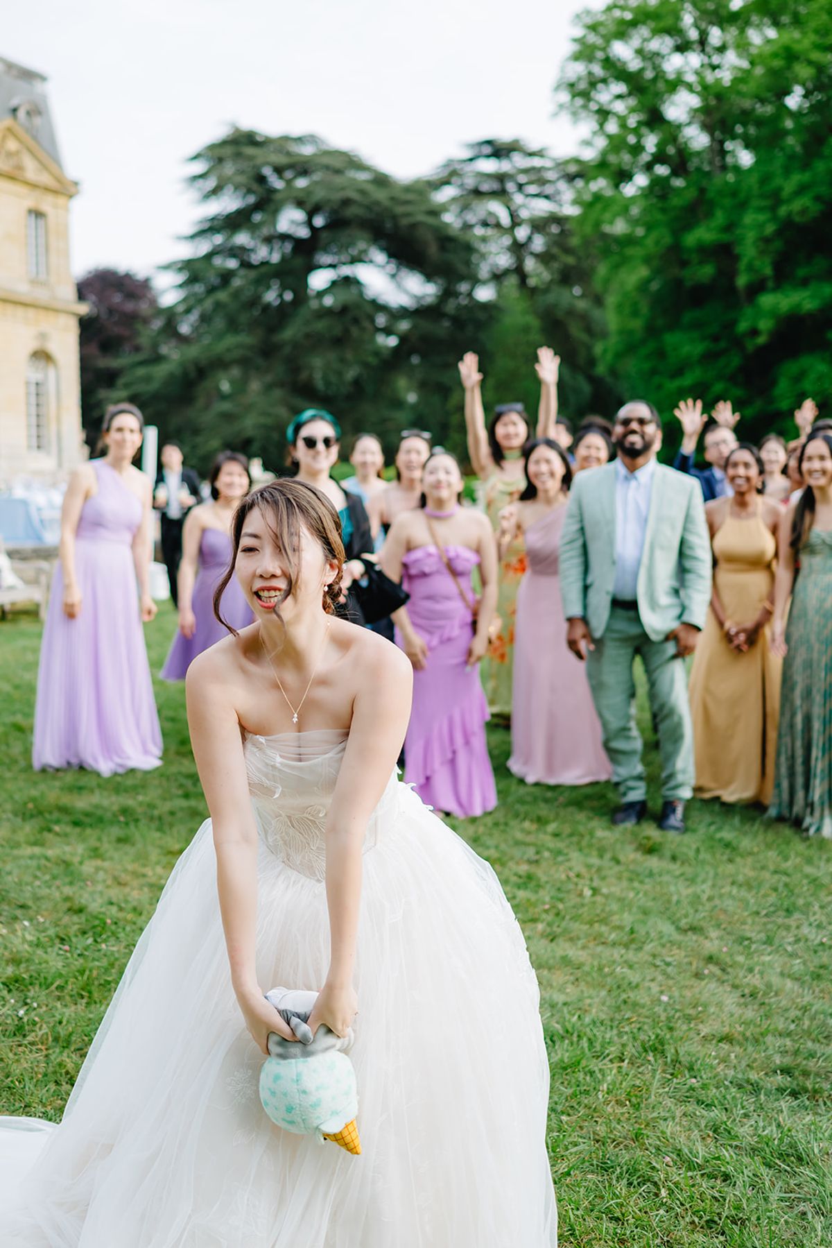 Liana with her bridal party cheering together on the lawn