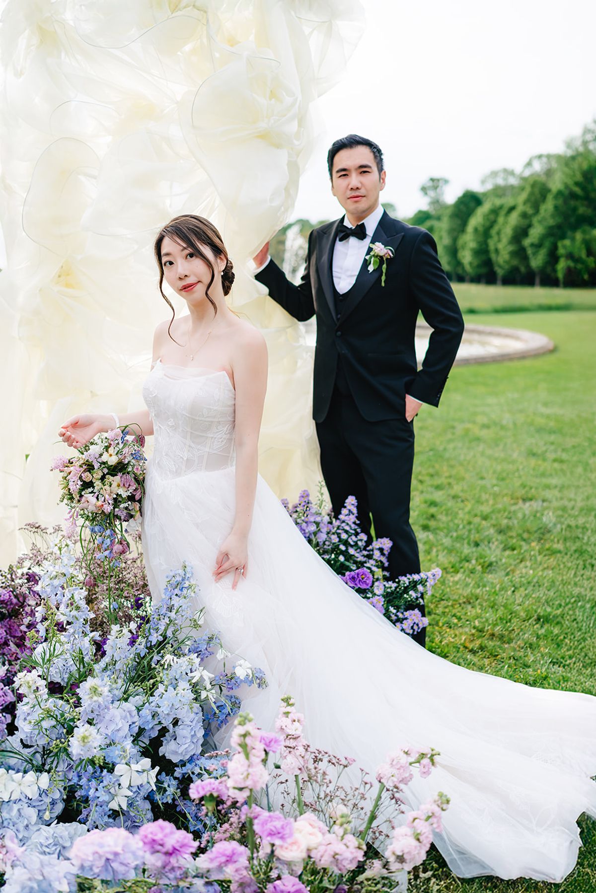 Liana and Ruiji posed together on the lawn at Château de Champlâtreux