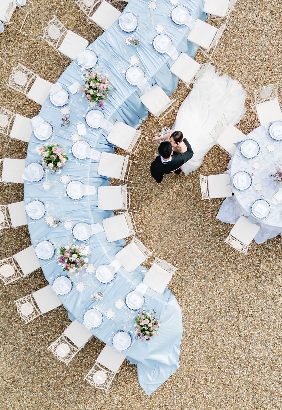Overhead view of the round reception tables set with blue linen and gold chairs