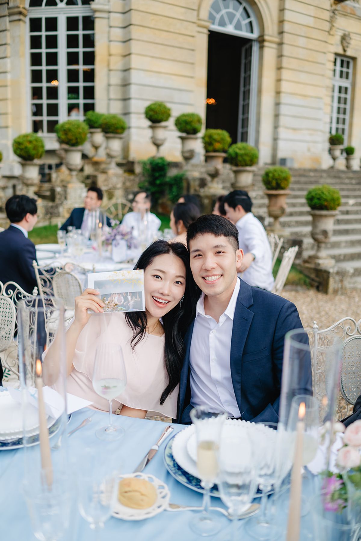 Guests laughing together at the reception table outdoors