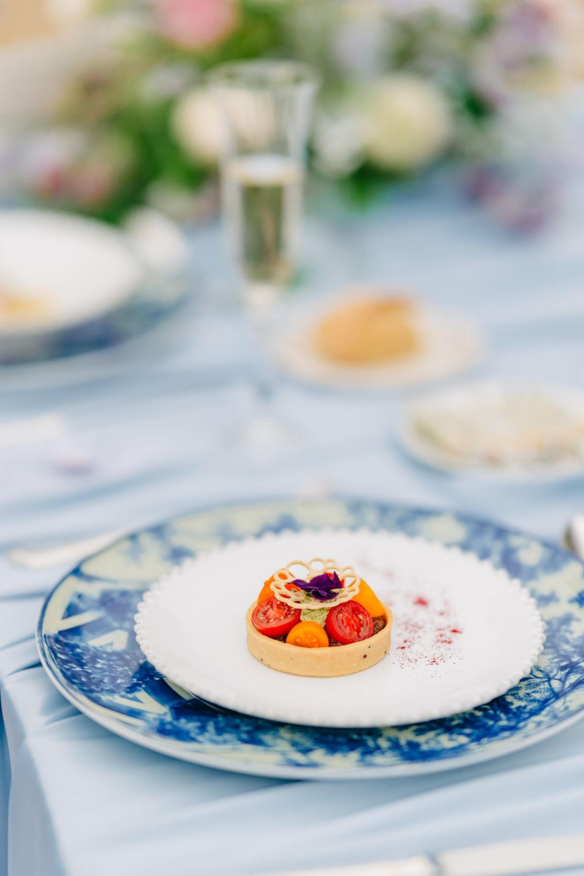 Dessert course detail, a small tart on a patterned plate