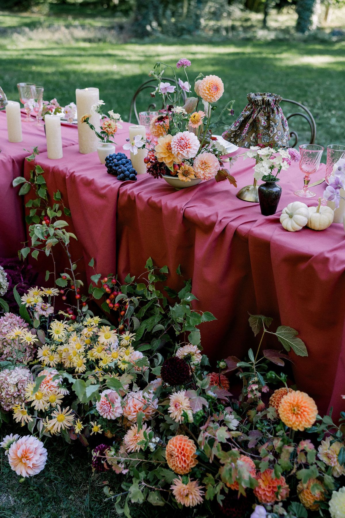 rectangular table with orange, pink and white flowers