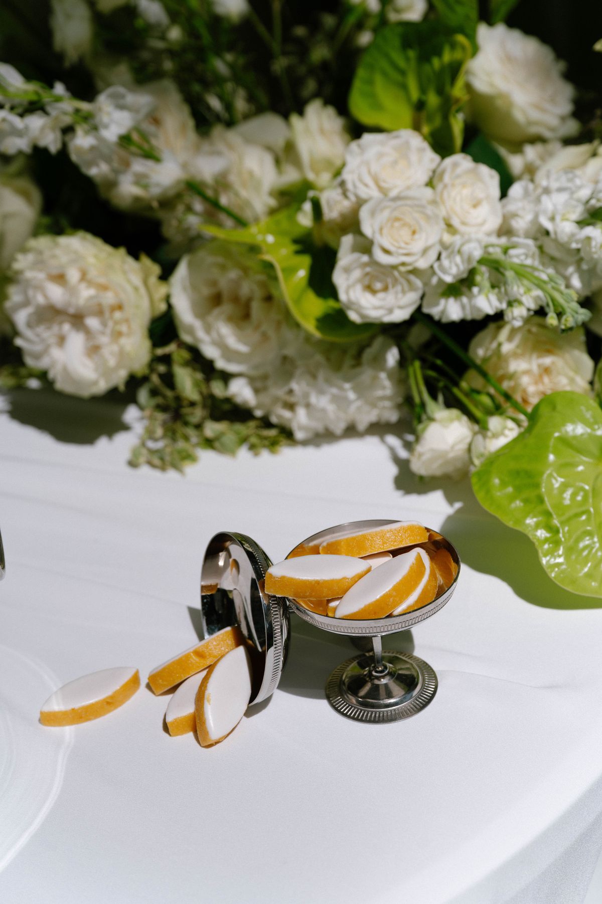 Wedding rings and a citrus garnish styled together on a table