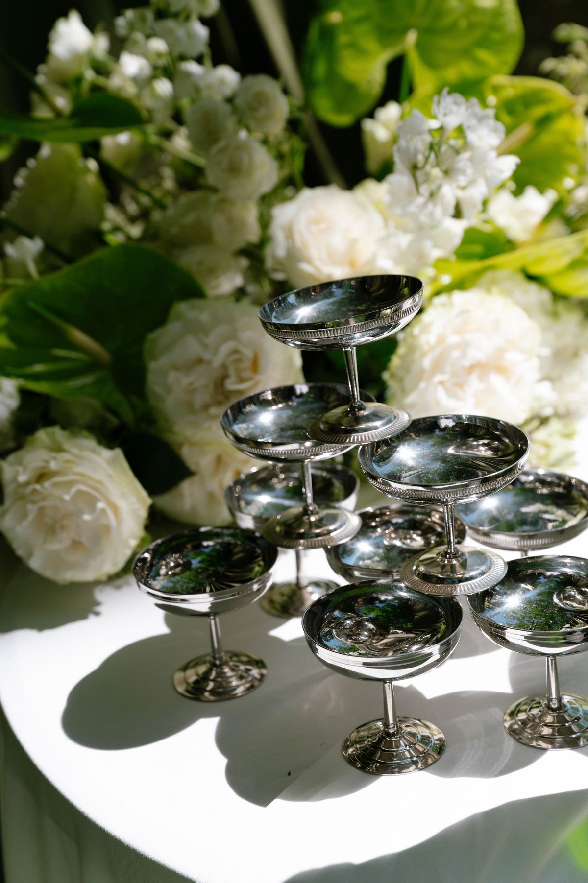Close view of the tiered silver coupe stand for the champagne display