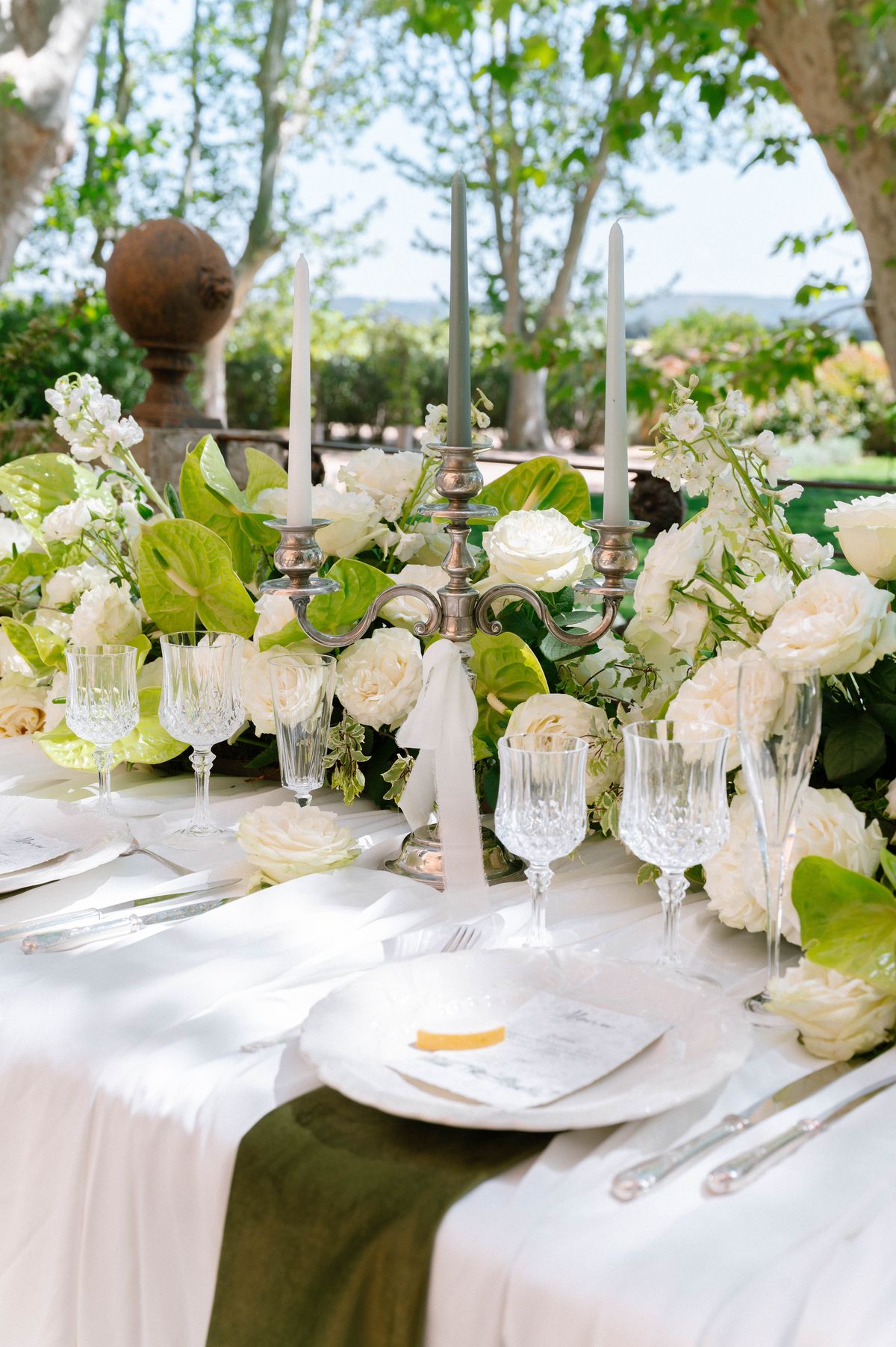Reception table detail with candelabra, white roses and glassware