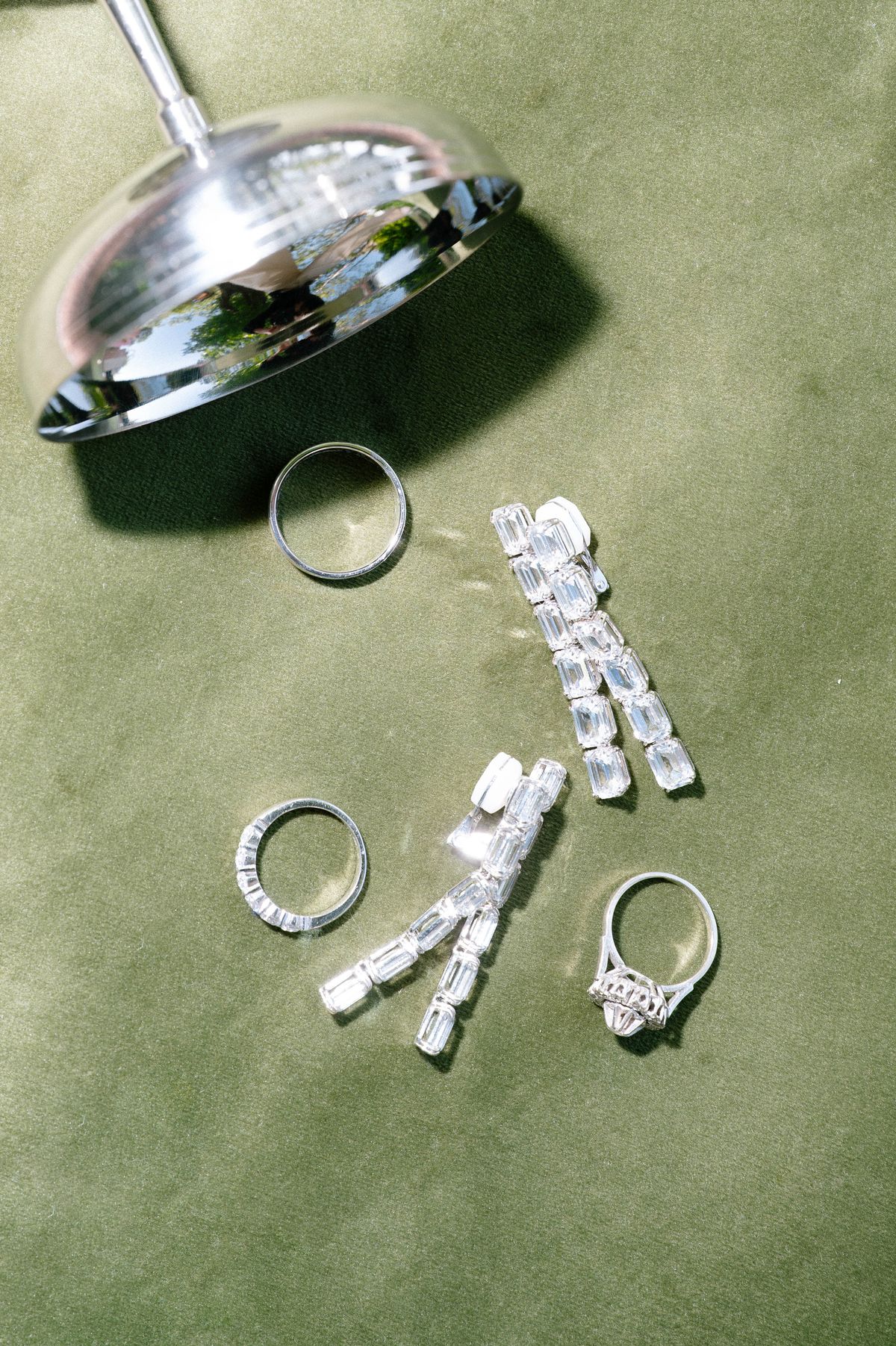 Wedding rings arranged on a moss-green velvet surface
