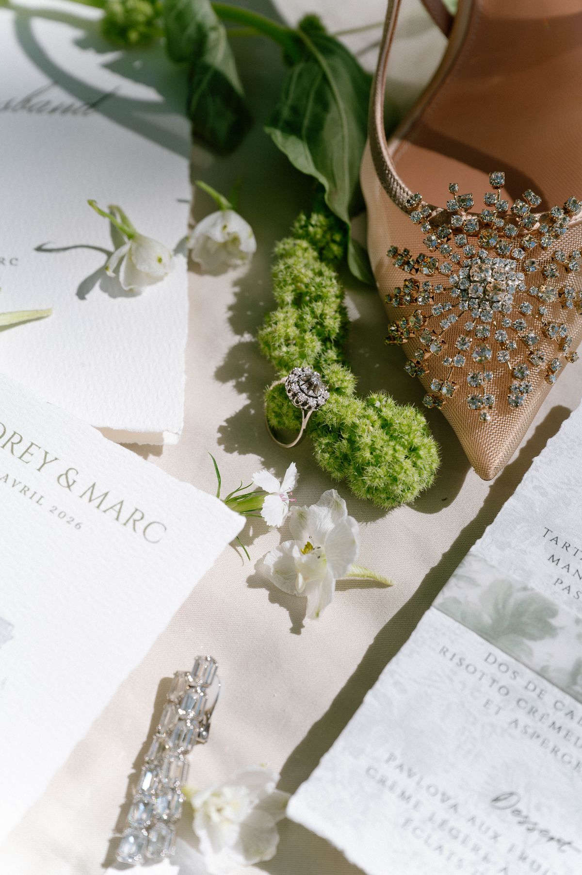 Wedding stationery, ring and a crystal-embellished clutch styled together