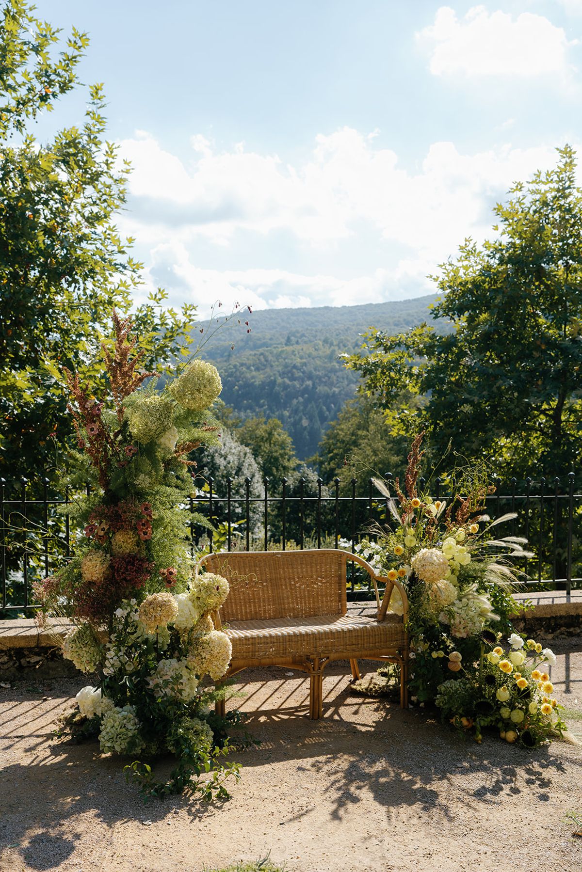 A garden bench dressed with white and green florals