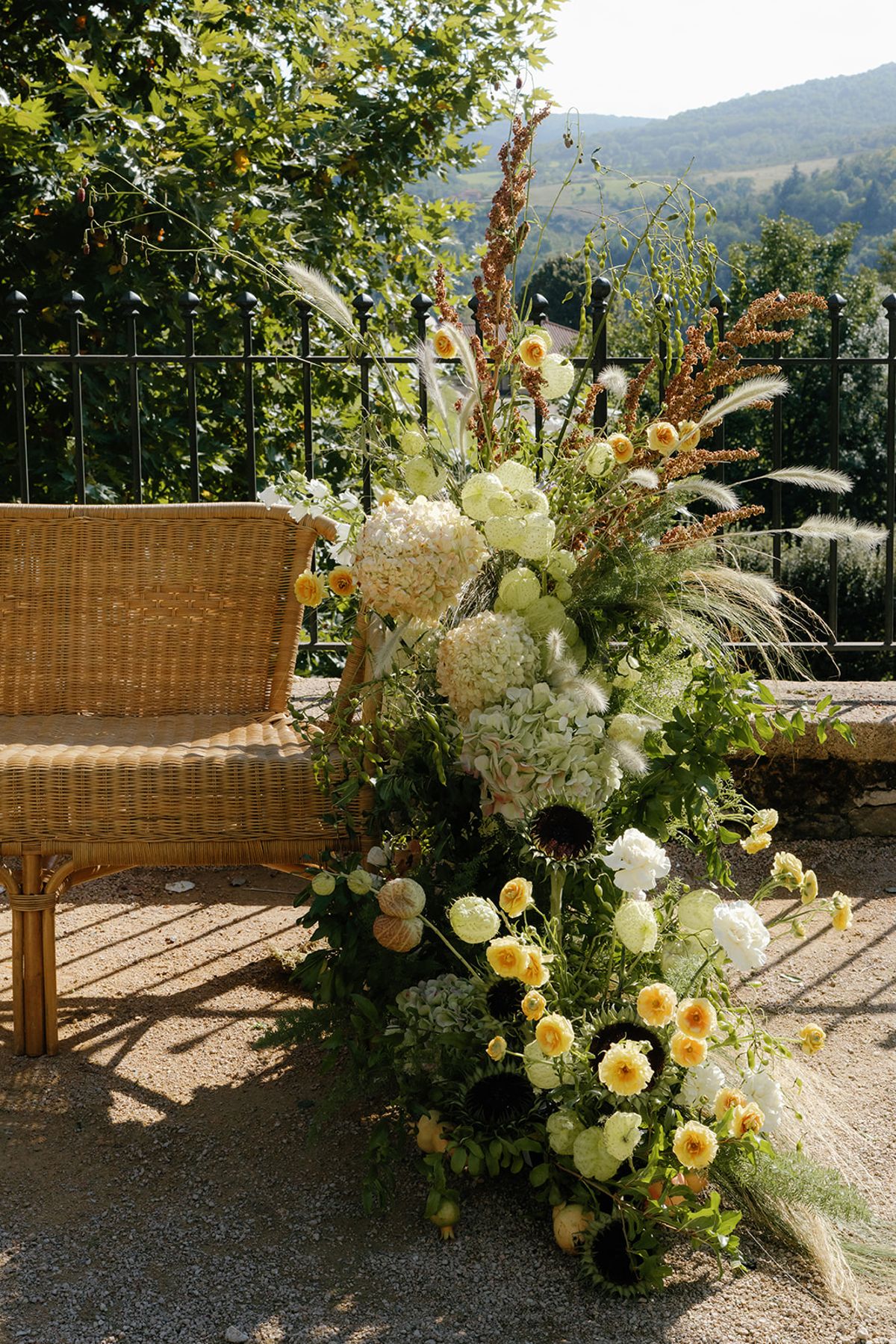 Wicker seating beside a floral installation in white and yellow
