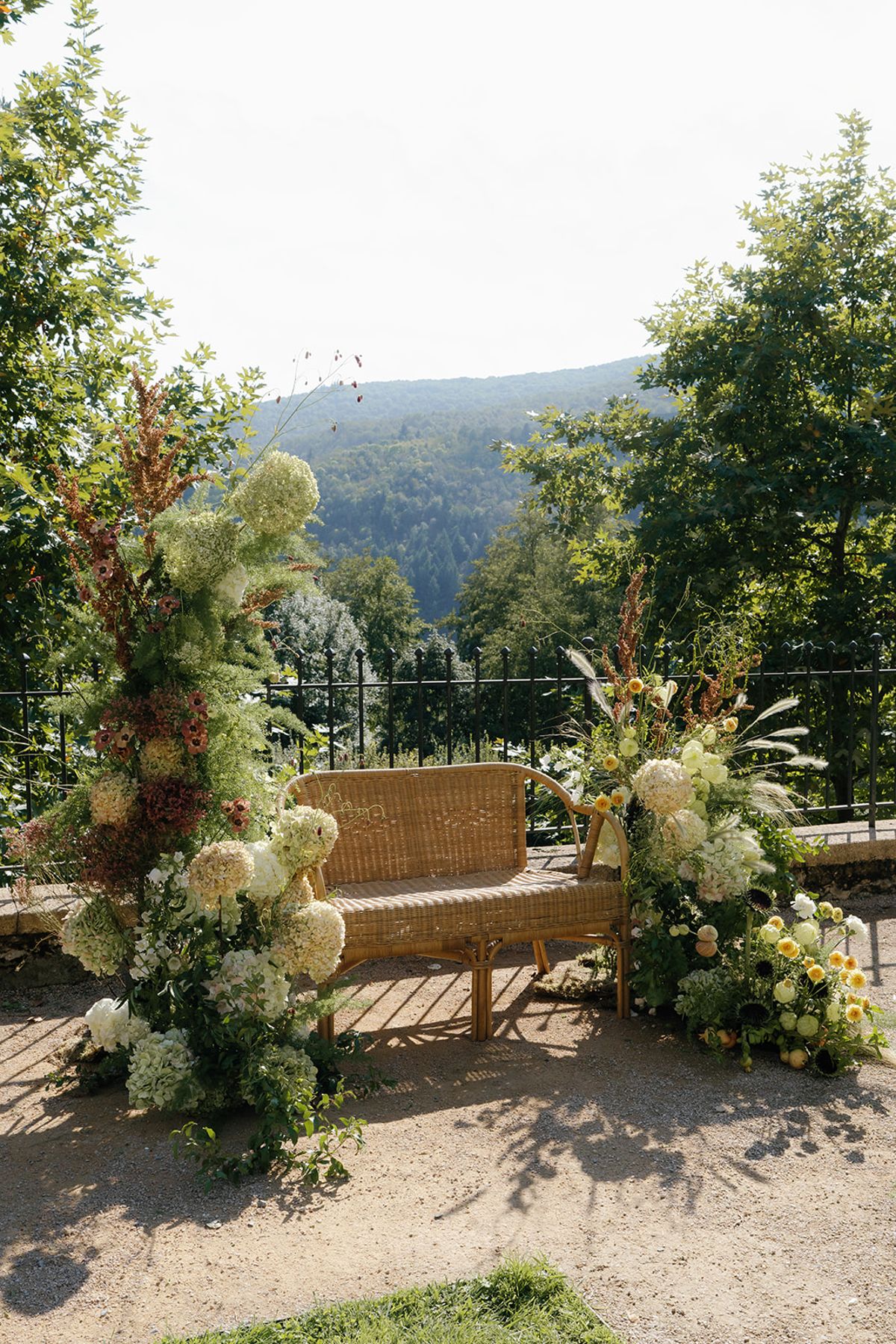 The ceremony backdrop of garden-gathered flowers and foliage