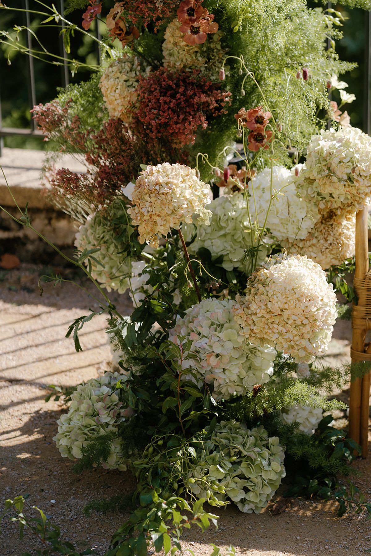 A floral installation set against the estate stonework