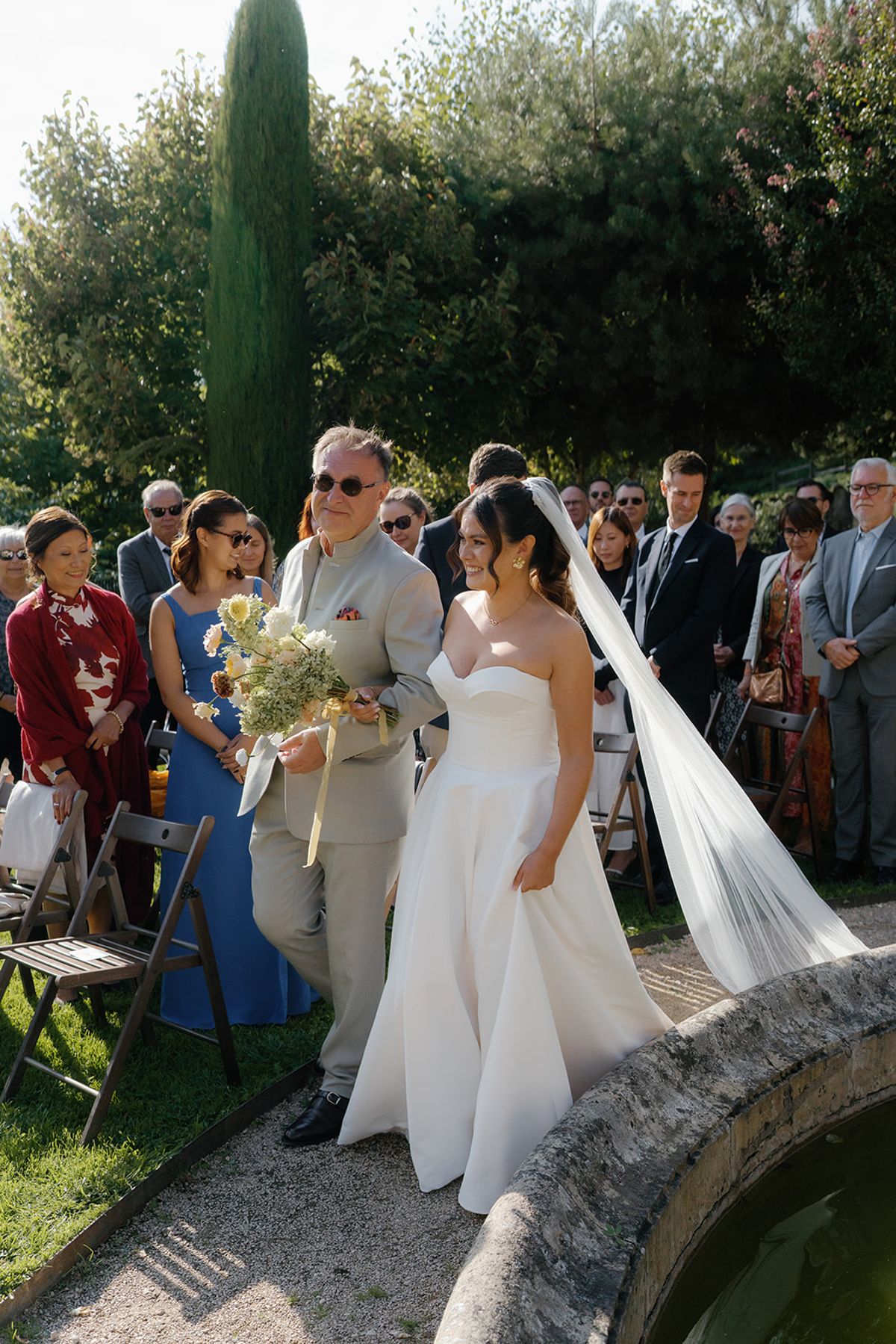 The bride on her way down the aisle past friends and family