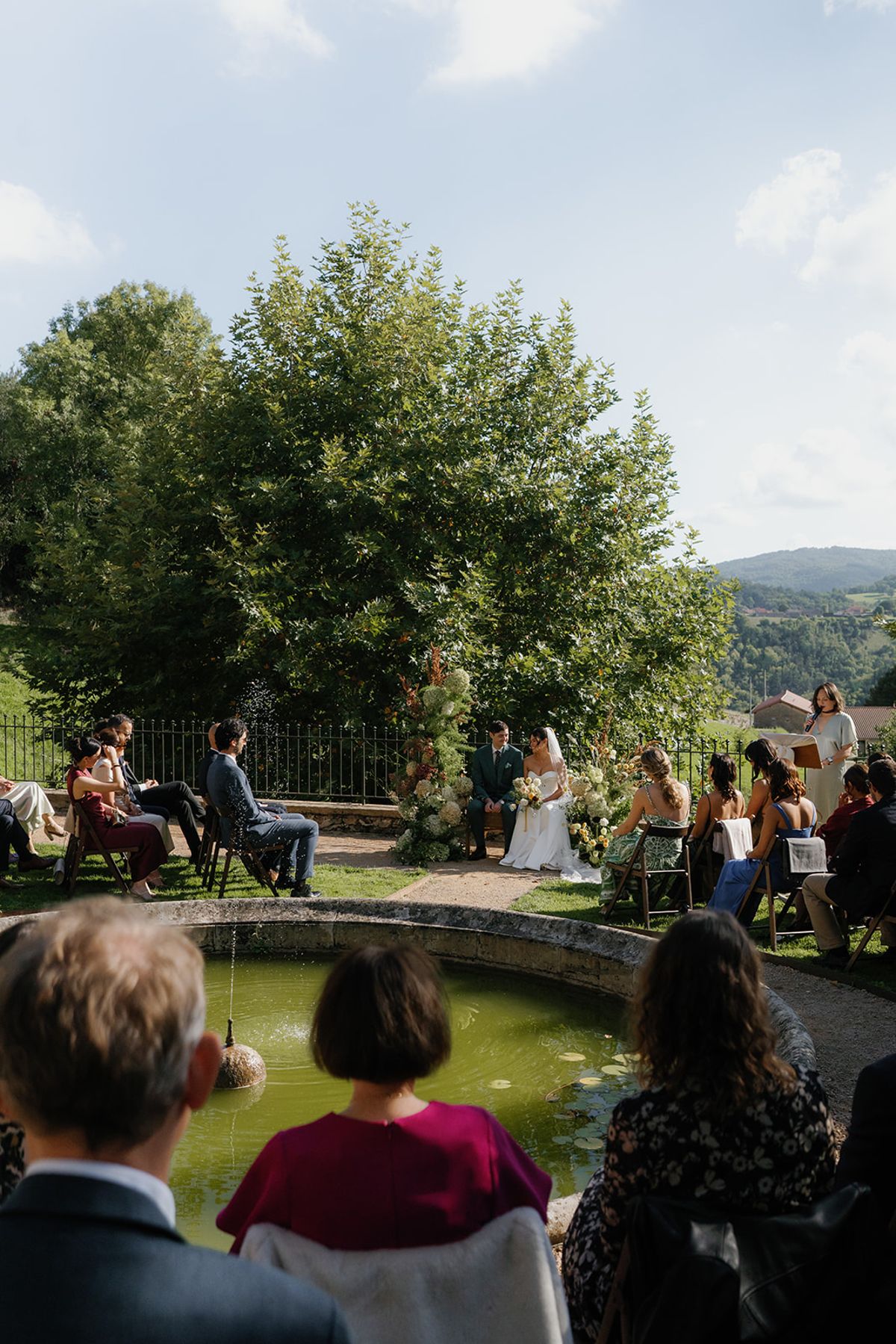 Guests watching the ceremony in the afternoon sun