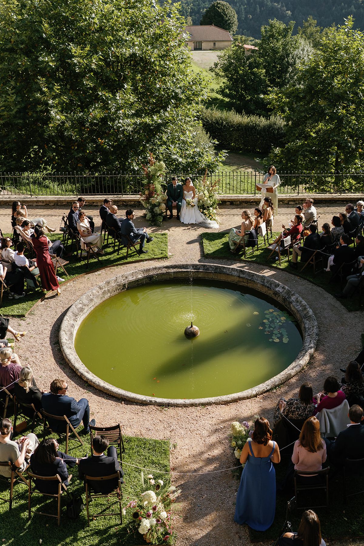 The full ceremony gathering around the garden pool