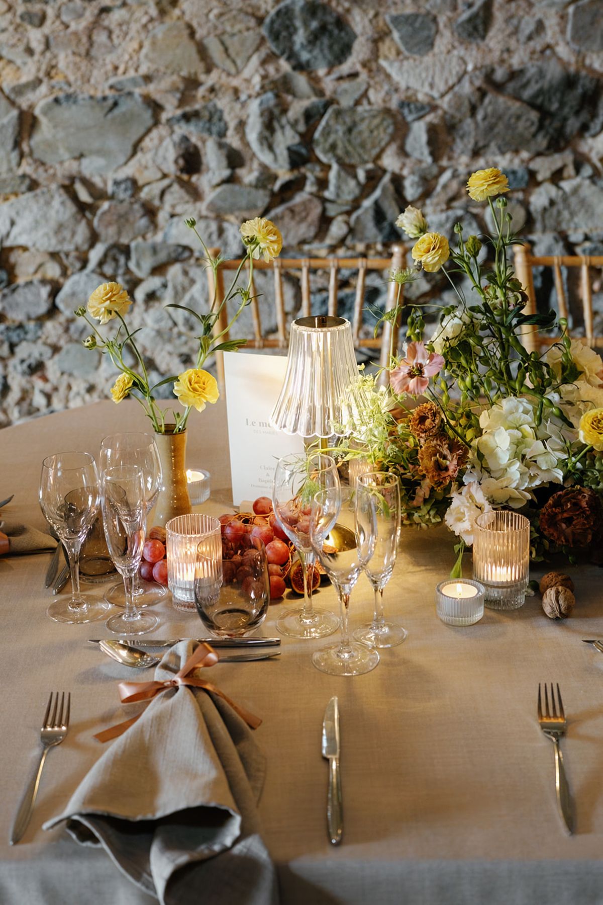 Candlelight, garden flowers and autumn fruit on the dinner table