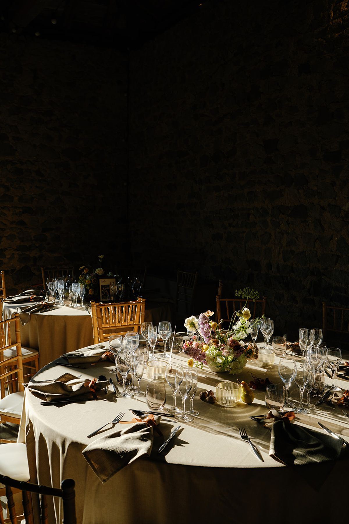 The dinner table dressed with seasonal florals and glassware