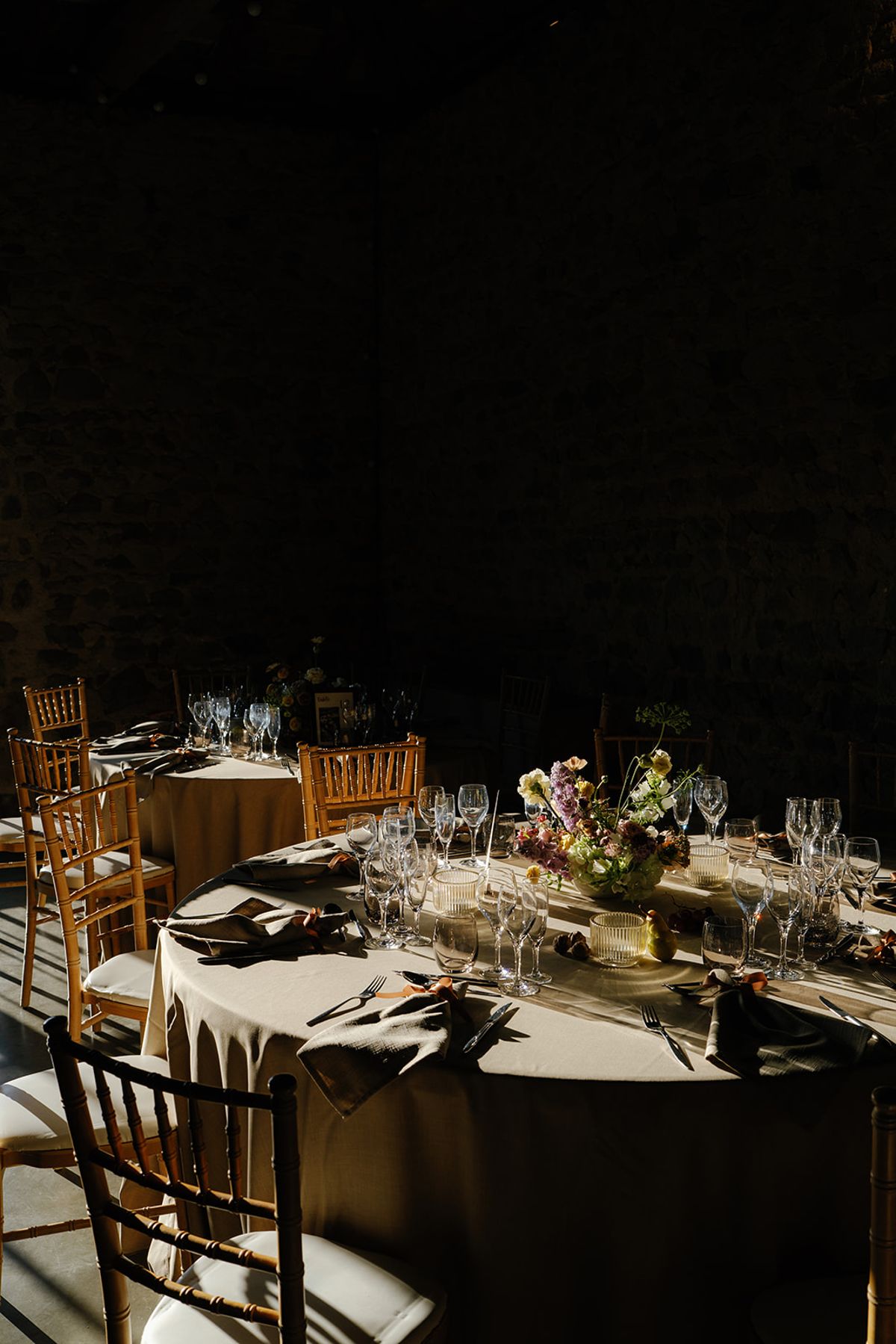 Place settings and low floral arrangements down the table