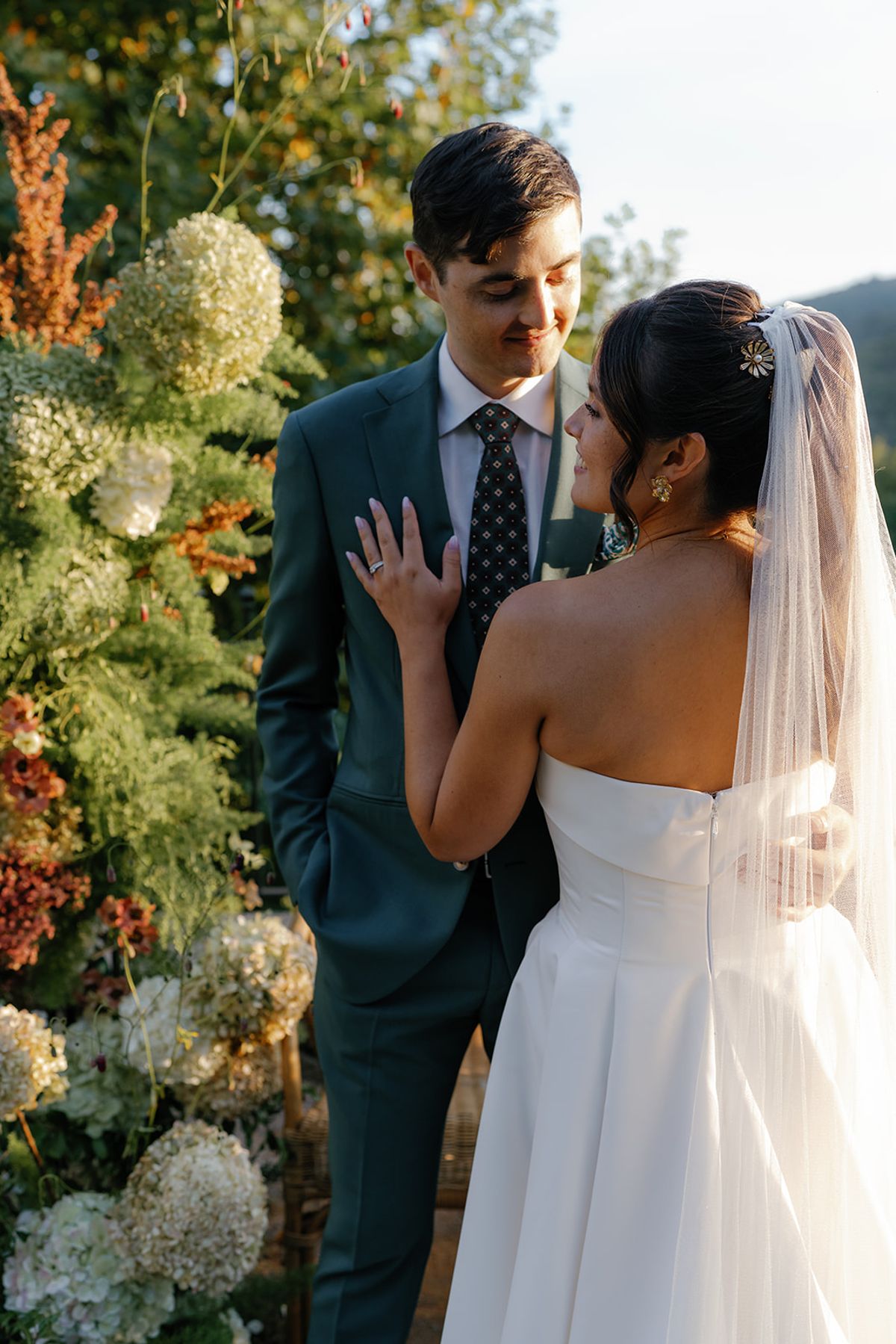 Claire and Baptiste together beside the ceremony flowers
