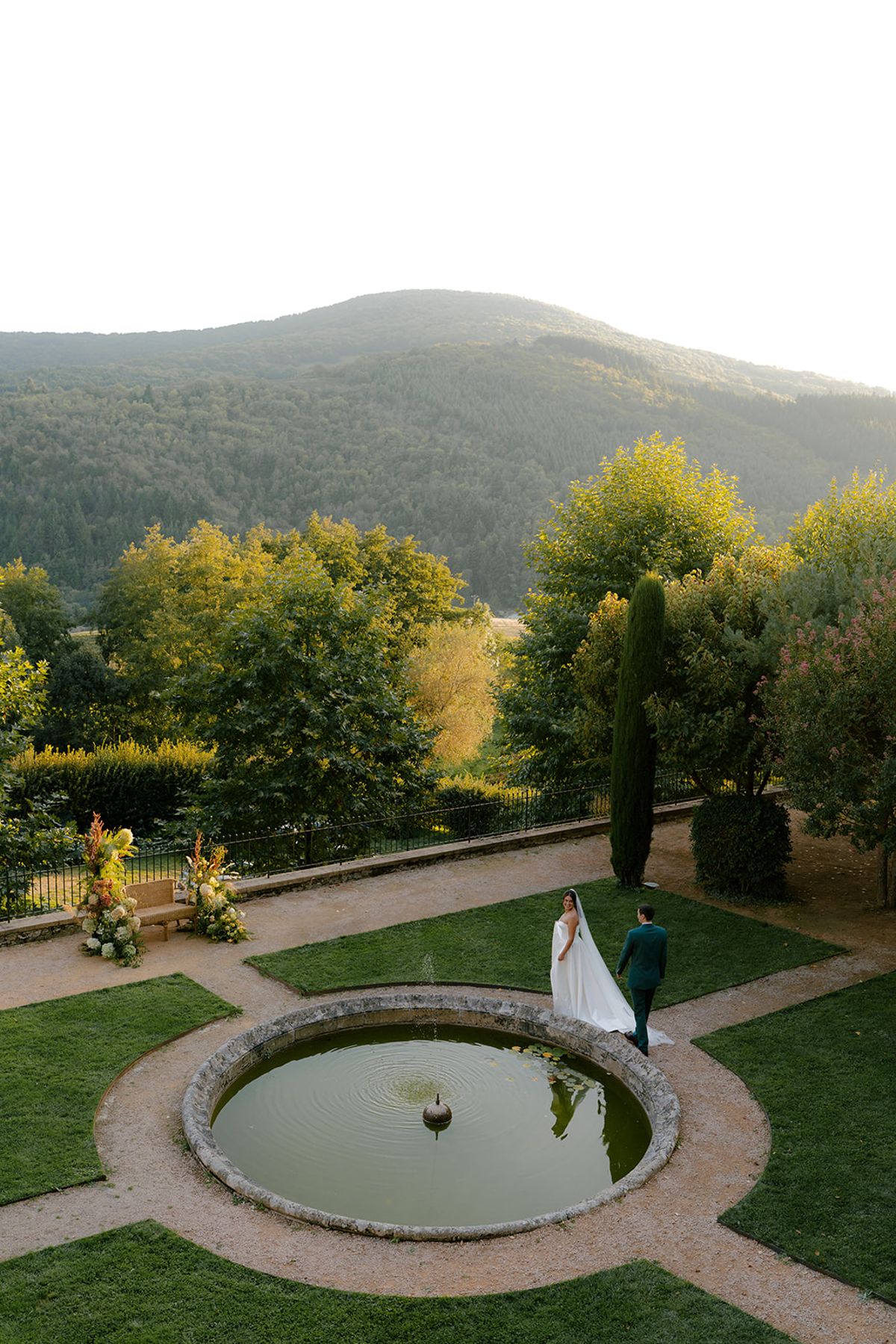 Claire and Baptiste alone in the formal garden as the light drops