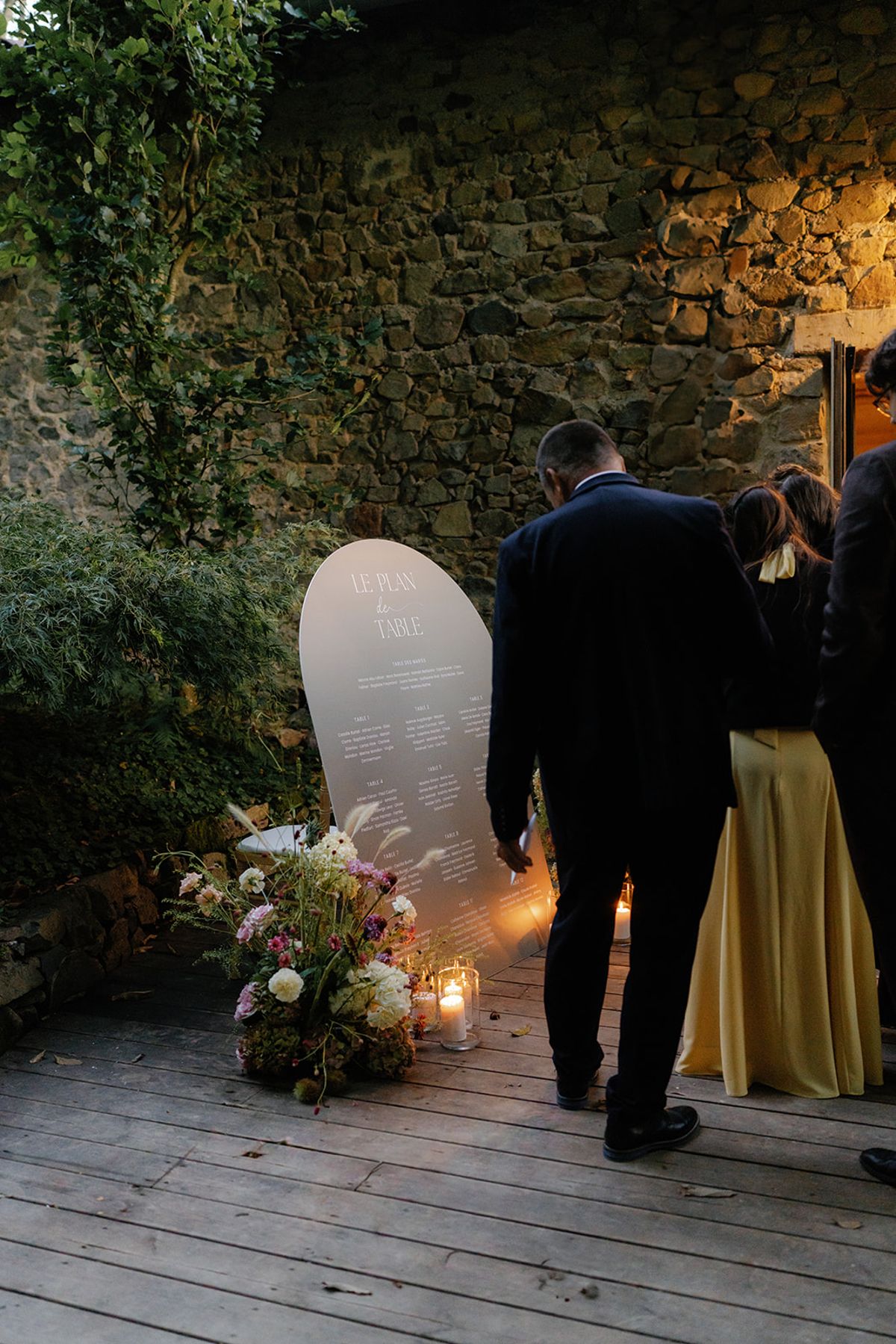 Guests moving through to dinner past candlelight