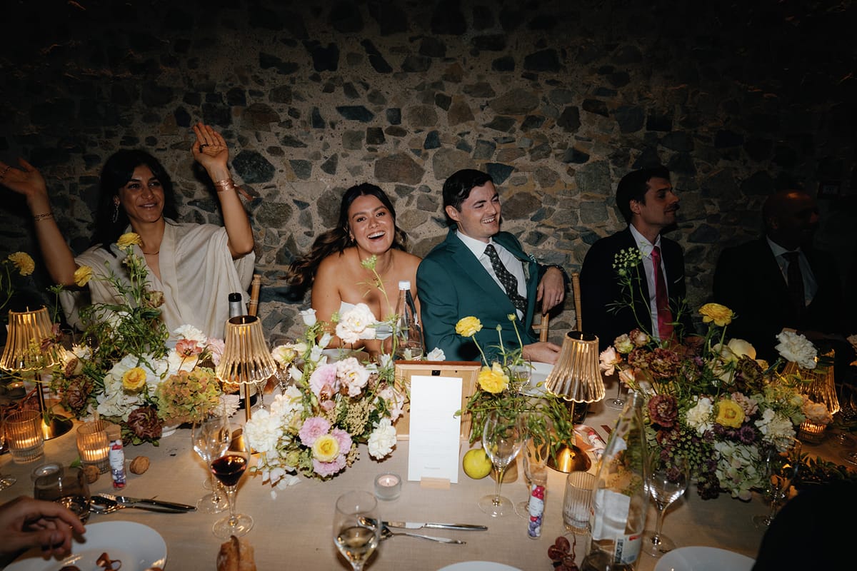 Guests raising a toast along the dinner table