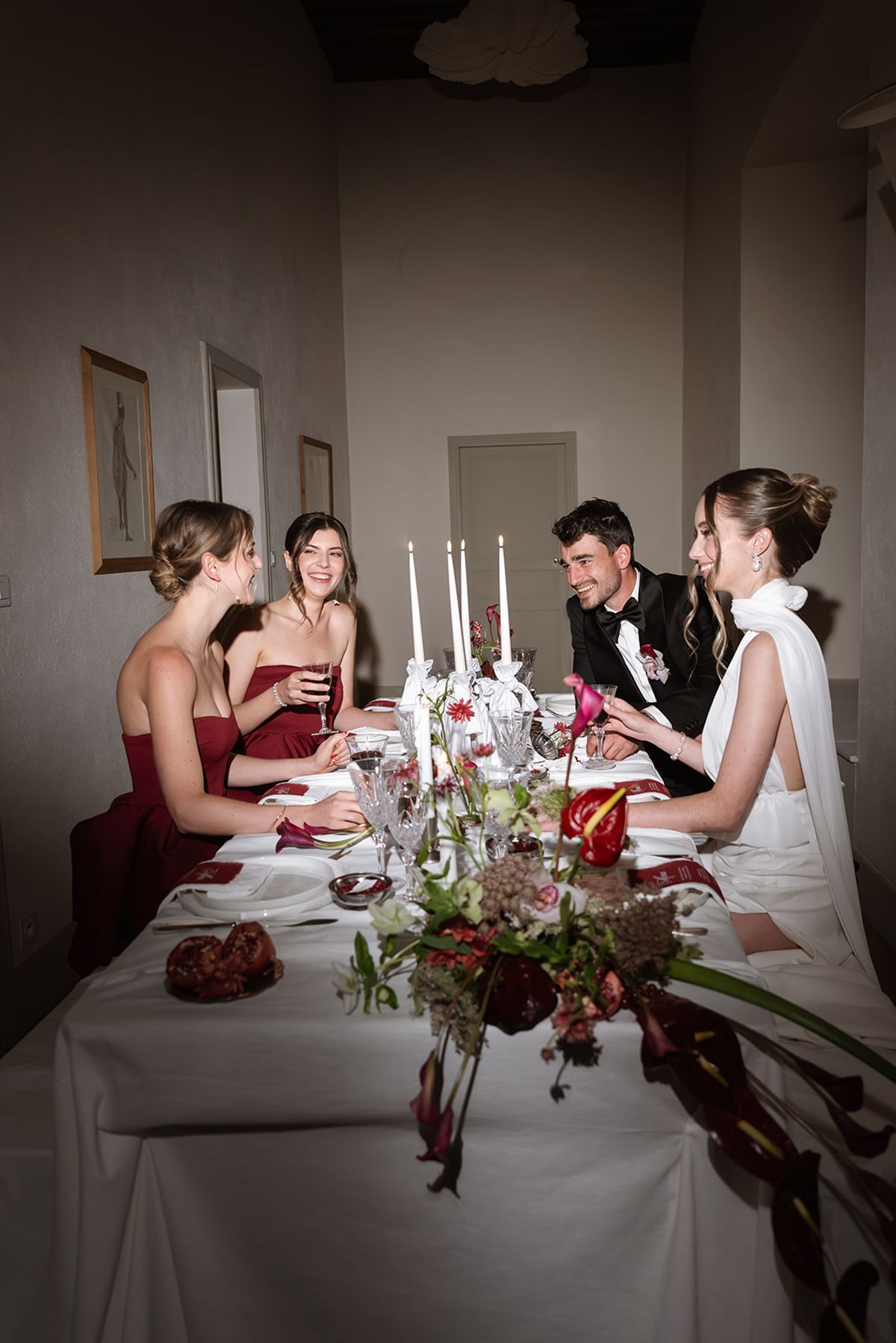 Bride, groom and bridesmaids at a candlelit dinner table