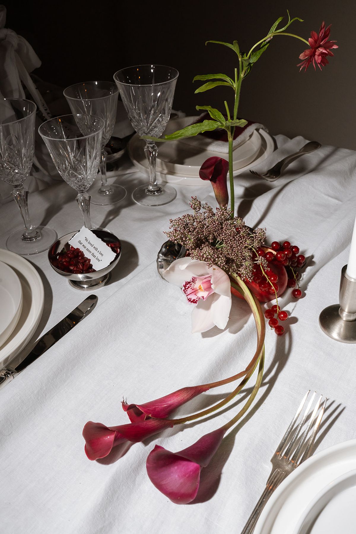 Table detail with calla lilies, an orchid and pomegranate seeds