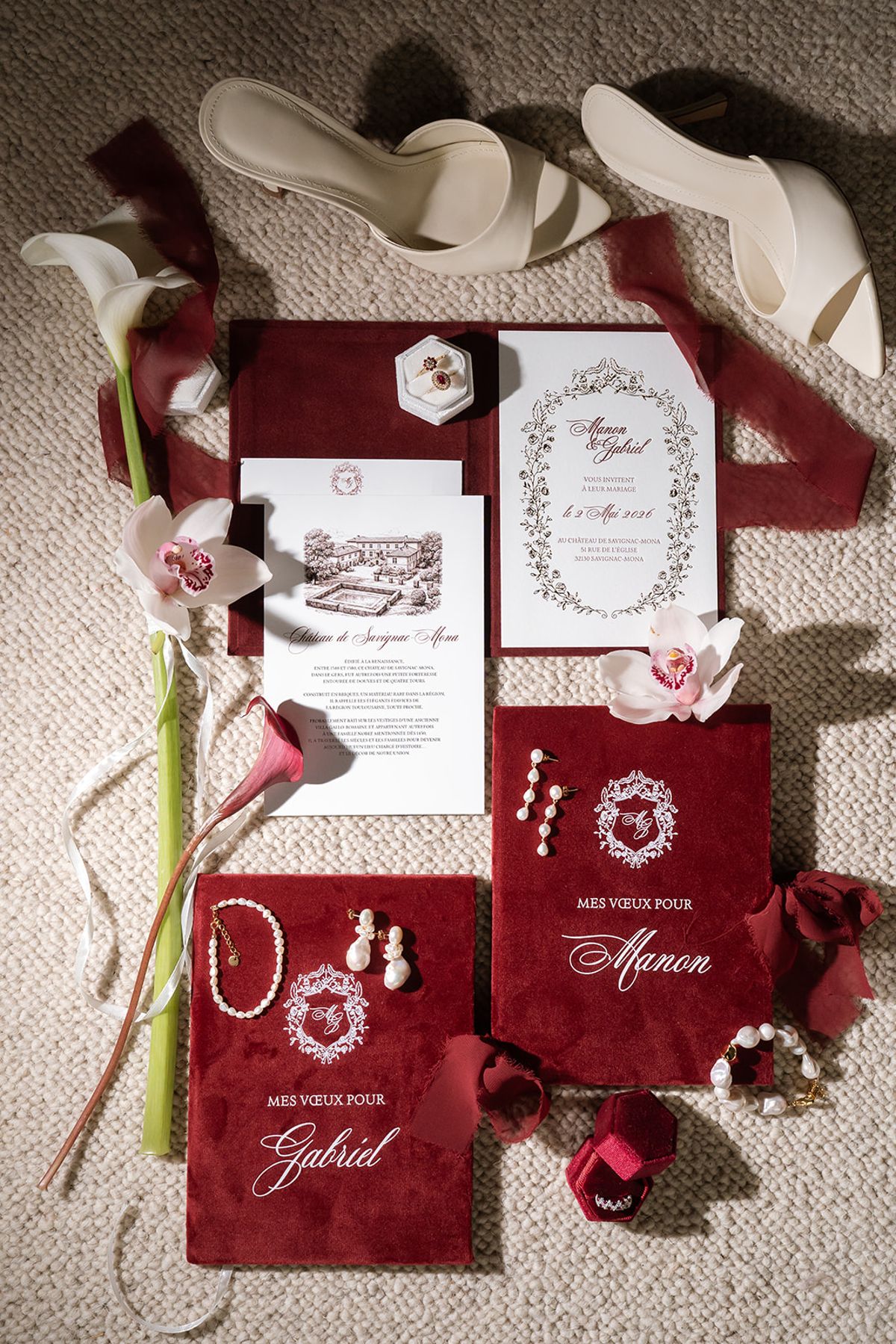 Wedding stationery suite with burgundy vow books, an invitation and bridal shoes