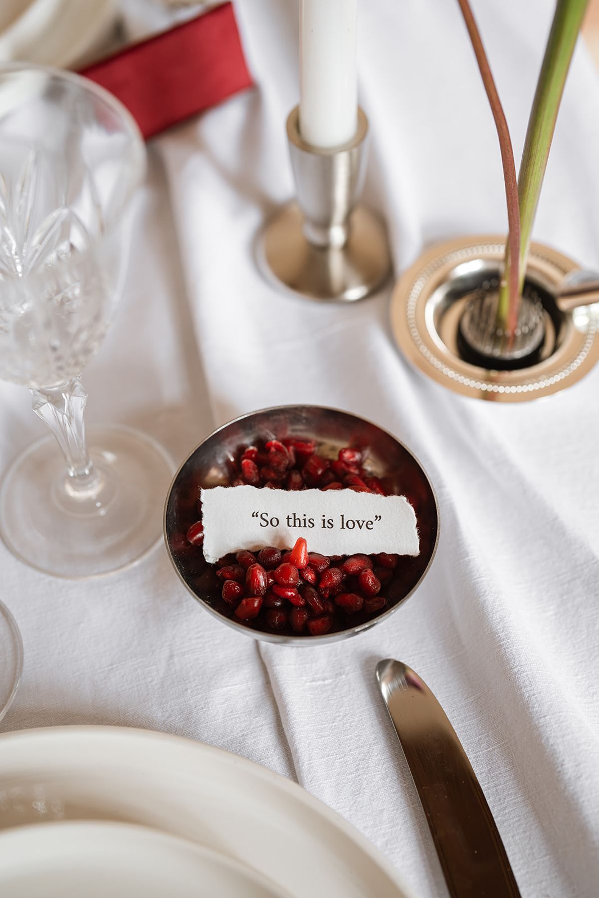 Bowl of pomegranate seeds holding a So this is love note