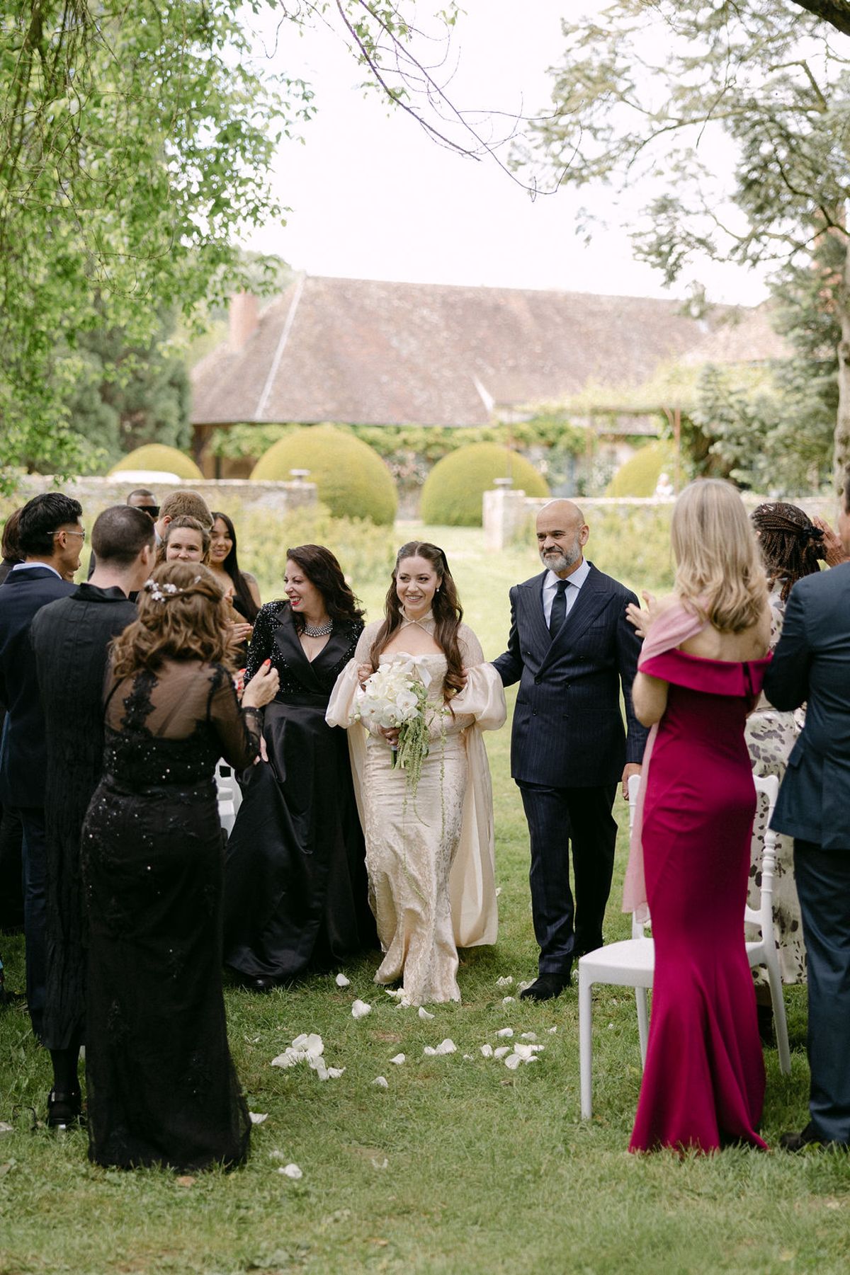 Guests embracing emotionally beside the ceremony aisle.