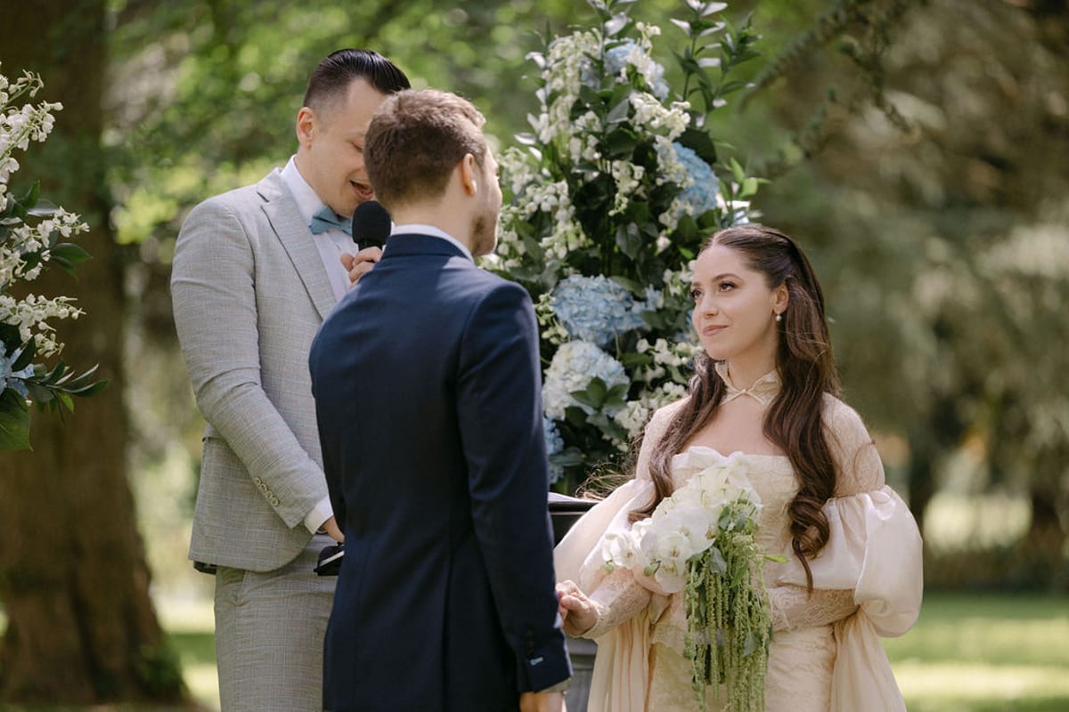 Olivia and Jonathan exchanging vows, facing each other during the ceremony.