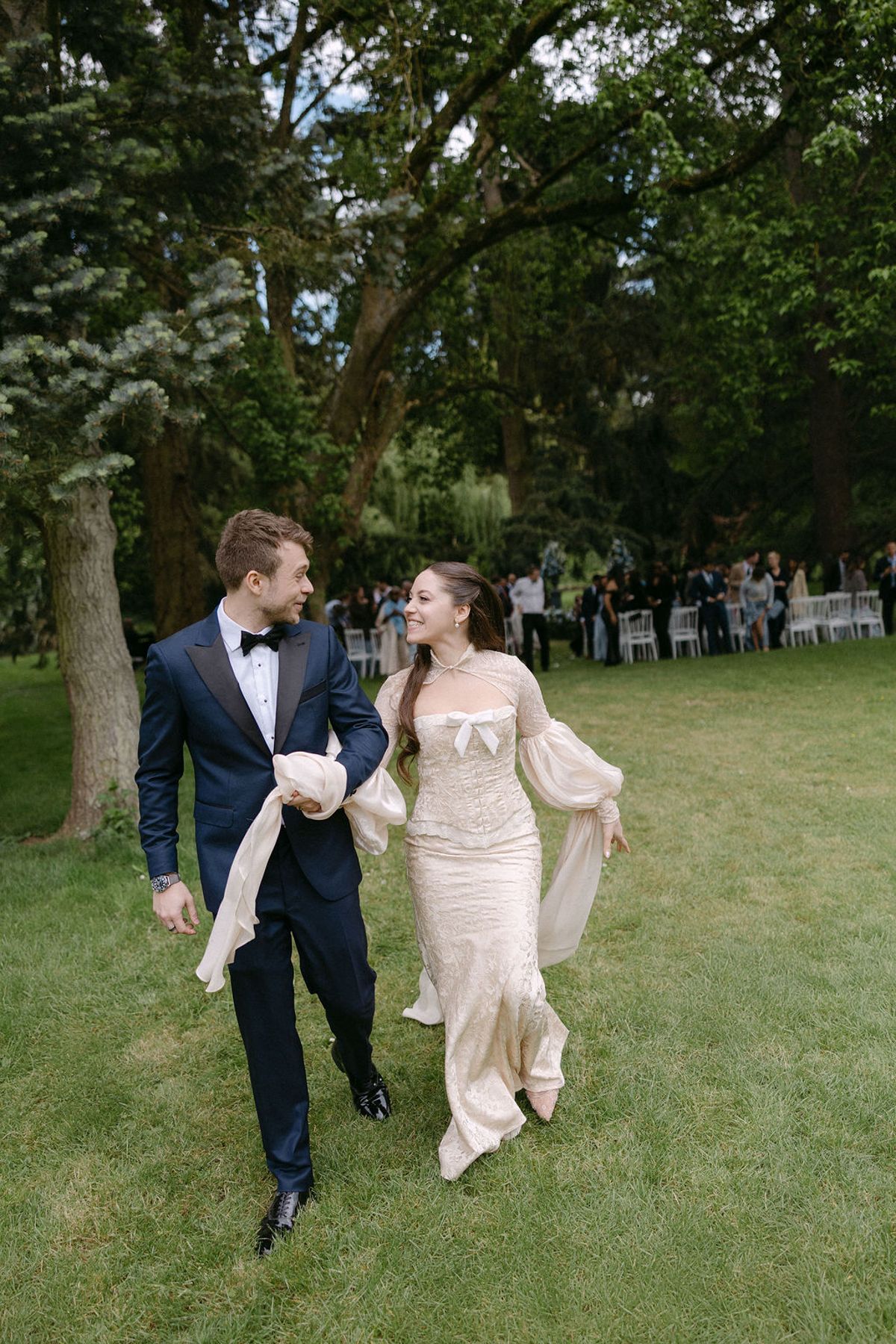 Olivia and Jonathan laughing together just after the ceremony, guests softly blurred behind them.