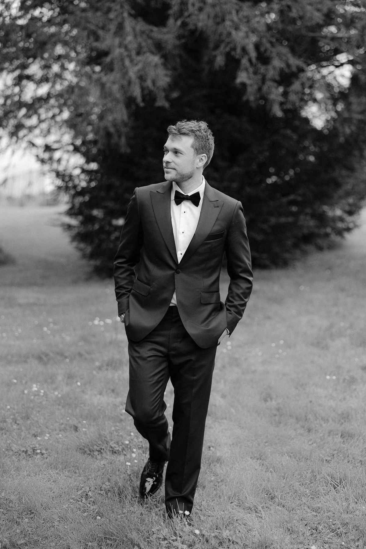Jonathan in a solo portrait, black and white, hands in pockets.