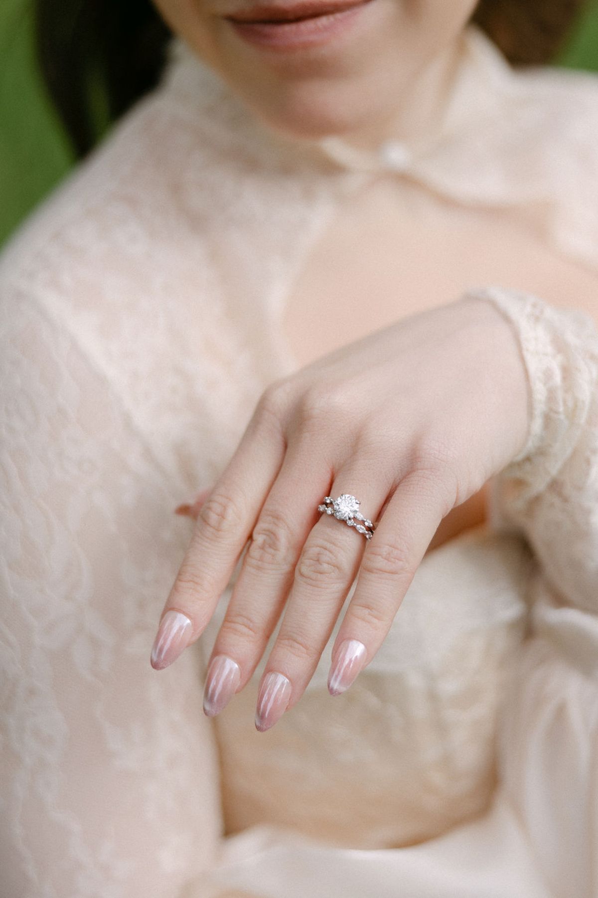 Close-up of Olivia's engagement and wedding rings on her hand.