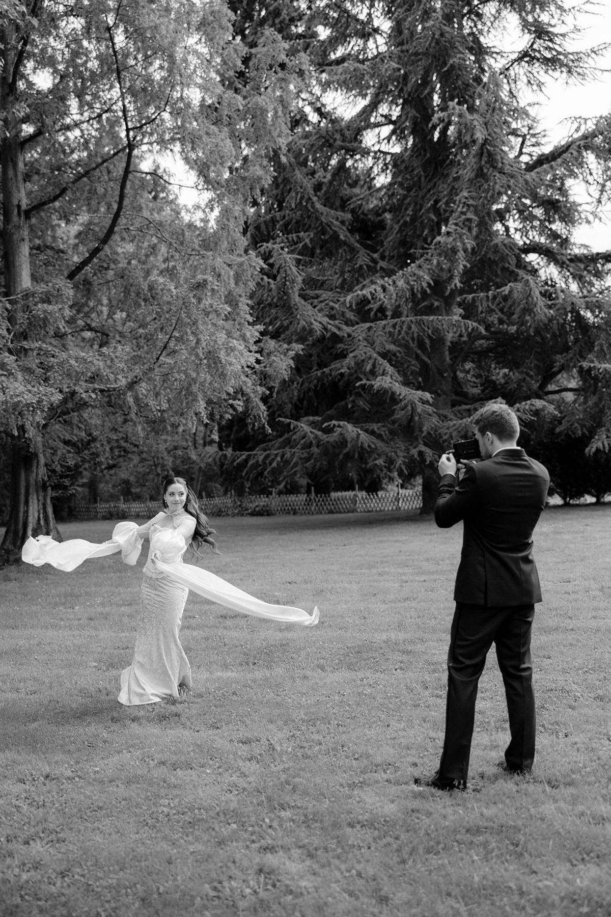 Olivia and Jonathan dancing and spinning together on the lawn, black and white.