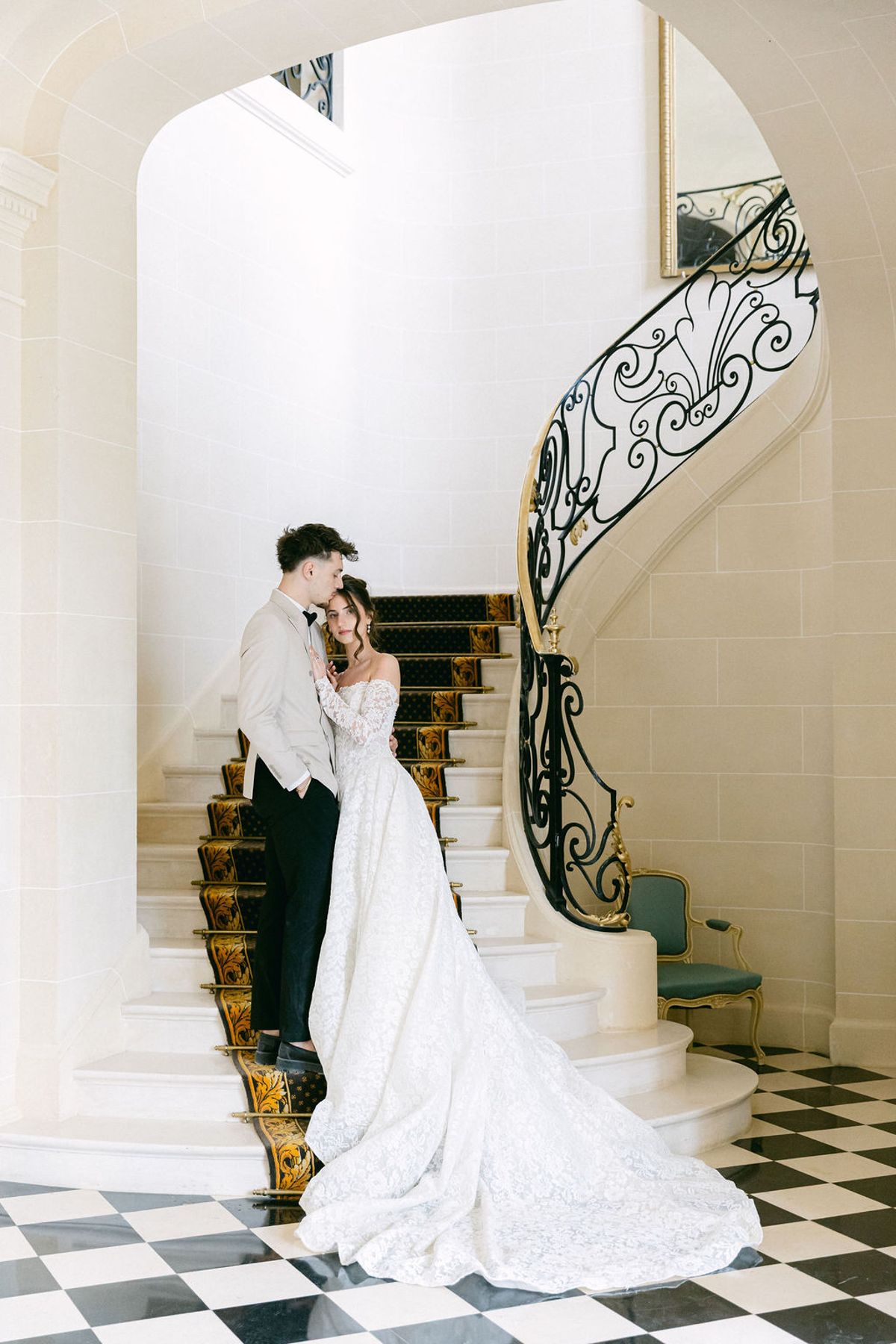 Couple on the chateau staircase above the chequerboard floor